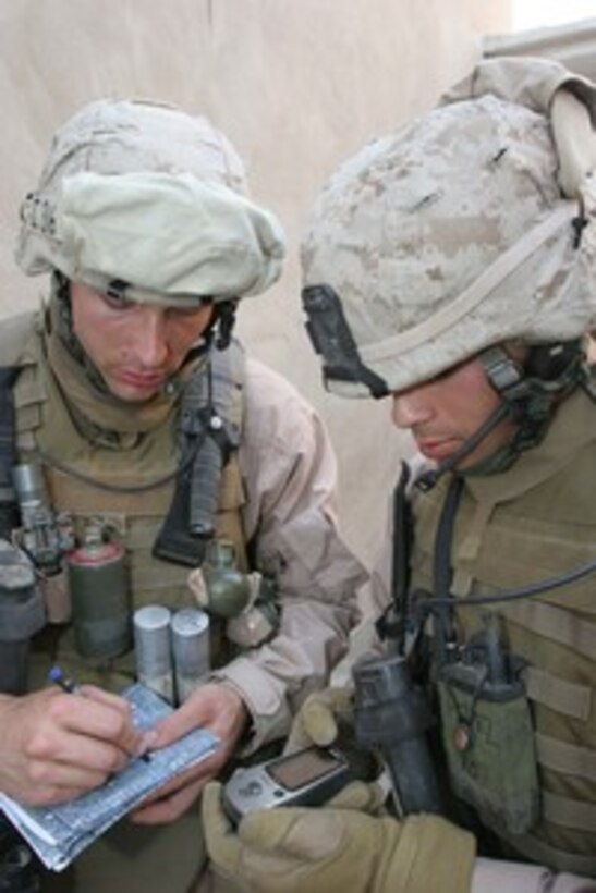 U.S. Marine Corps Lance Cpl. Steven T. Gianetto and Cpl. Luis M. Perez receive their location coordinates via a global positioning system in Ramadi, Iraq, on April 25, 2006. Gianetto and Perez are attached to India Company, 3rd Battalion, 8th Marine Regiment. 