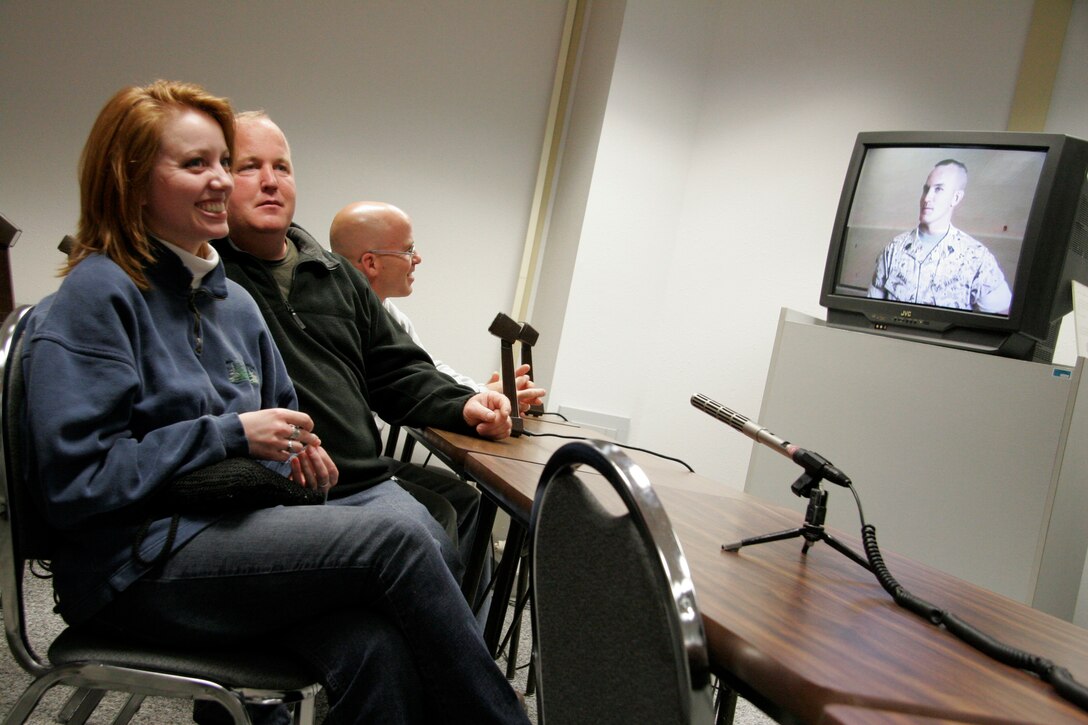 Kevin Kasal, right, and Kelly Kasal, along with Kelly's girlfriend, Sarah Winters, speak to their brother, Sgt. Maj. Bradley A. Kasal, after he was awarded the Navy Cross on May 1, 2006, via live video teleconference at the Southwestern Community College in Creston, Iowa. The VTC was arranged in order to allow Gerald Kasal, the Marine's severely ill father who couldn't travel, to witness the ceremony. Unfortunately, he passed away on April 30. Kasal, who was also promoted to the rank of sergeant major during the ceremony at Camp Pendleton, Calif., earned the Marine Corps' second highest award for combat heroism by selflessly shielding a Marine from an exploding grenade thus saving his life in Fallujah, Iraq, in November 2004. Kasal, a 39-year-old native of Afton, Iowa, is scheduled to return to his home state at the end of May to serves as the sergeant major of the Marine Corps recruiting station headquartered in Des Moines. (Photo by Staff Sgt. Bill Lisbon)