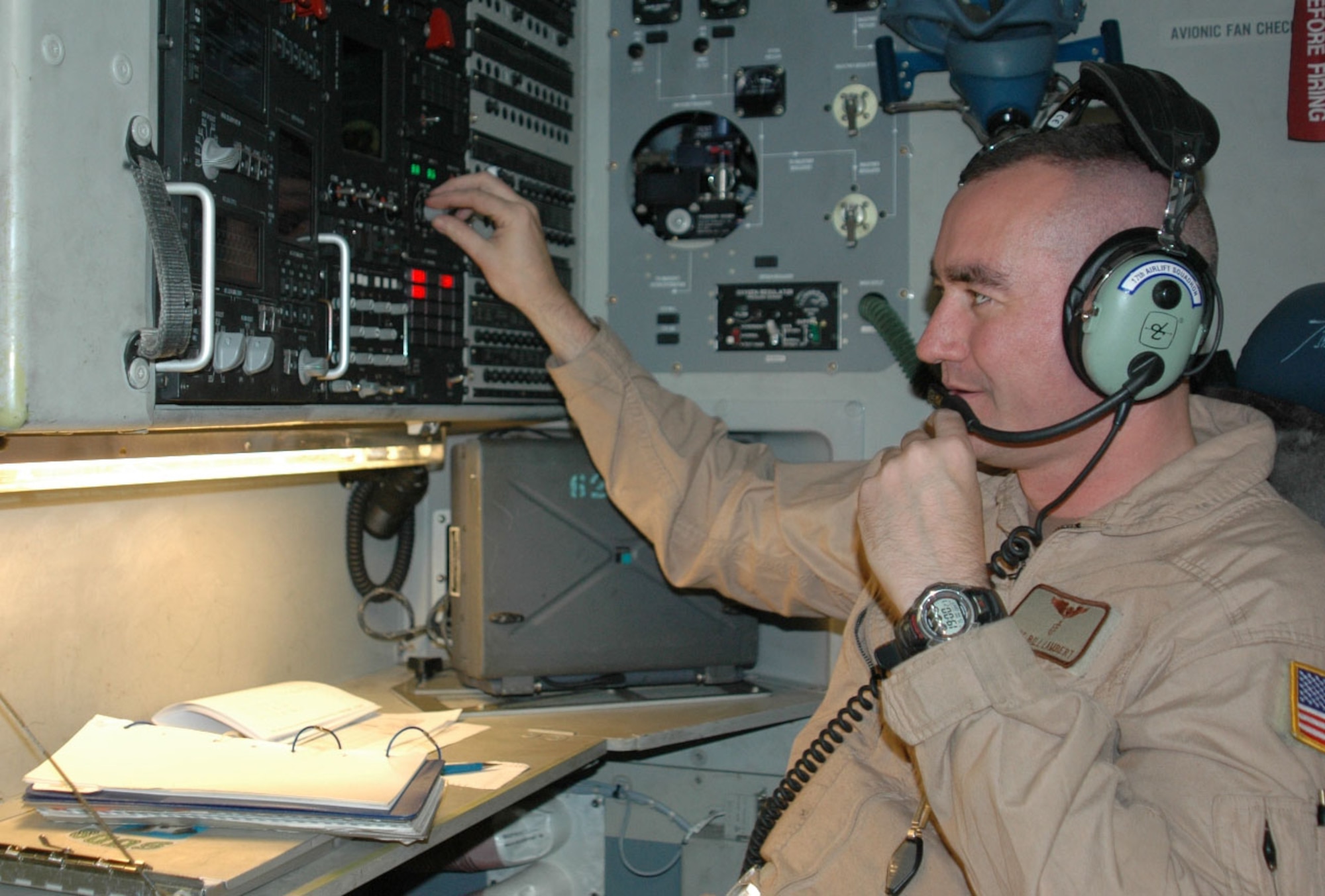 Master Sgt. Bill Lambert, a C-17 Globemaster III loadmaster, changes settings on the radio system in his aircraft before a mission in Southwest Asia. The sergeant is with Detachment 2, 817th Expeditionary Airlift Squadron. The unit flies C-17s throughout the region, carrying troops and supplies. (U.S. Air Force photo/Maj. Ann Peru Knabe) 

