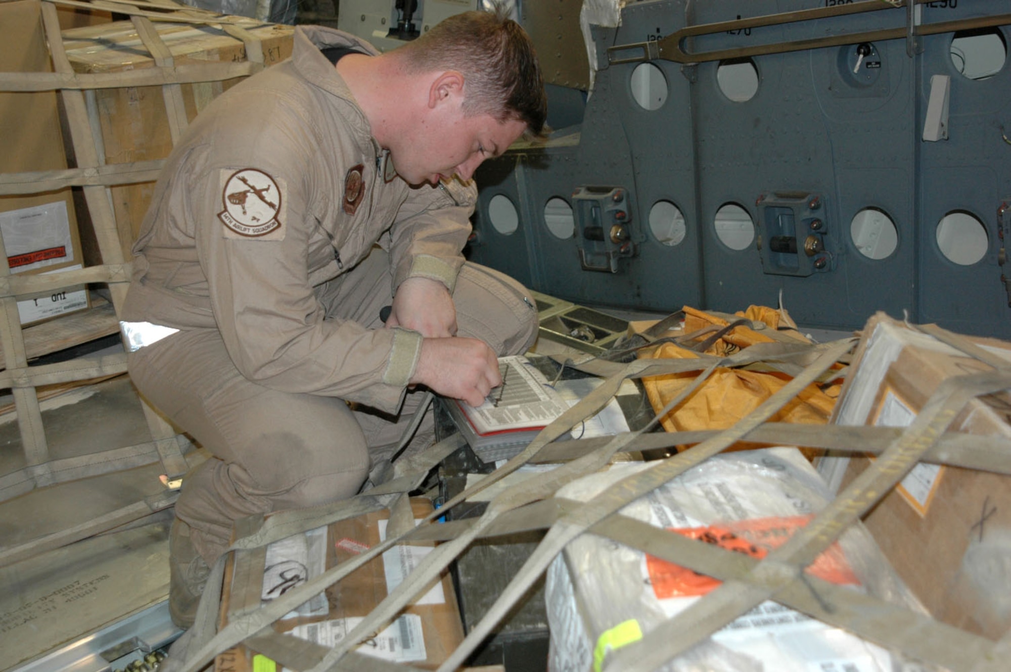 Senior Airman Steve Baird, C-17 Globemaster III loadmaster, reviews a cargo manifest for a mission in Southwest Asia. The Airman is with Detachment 2, 817th Expeditionary Airlift Squadron. The unit flies C-17s throughout the region, carrying troops and supplies. (U.S. Air Force photo/Maj. Ann Peru Knabe)