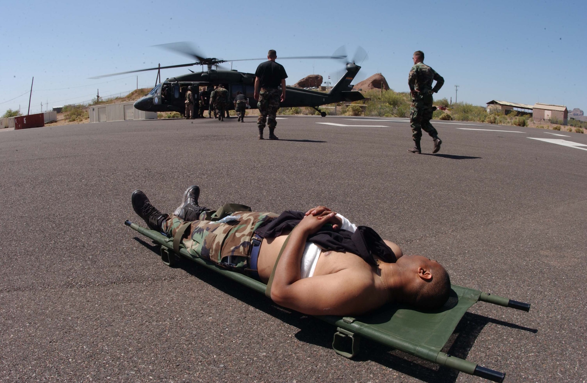 Senior Airman Anthony Carter, 944th Medical Squadron records administrator, awaits a medivac to the Maricopa County Burn Center during a disaster preparedness exercise April 26, 2006. Airman Carter was a simulated burn victim during the week-long exercise that involved active duty, Guard and Reserve units from across the United States and local community hospitals and businesses. (U.S. Air Force photo/Master Sgt. Garrett McClure)