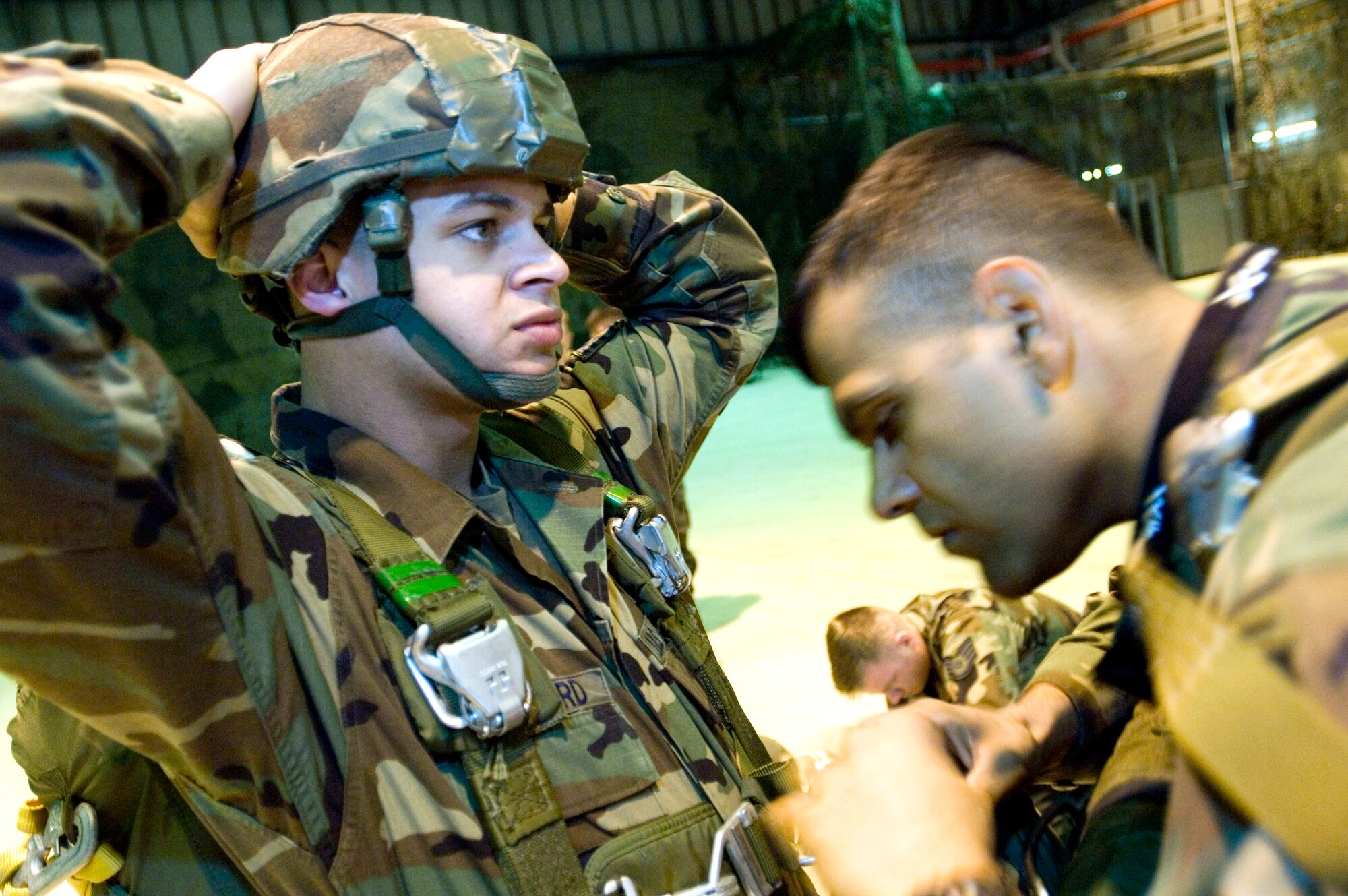 Army 1st Lt. Rajesh Ramlakhan verifies that Staff Sgt. James Woodford's parachute is safe and ready for the day's mission prior to launching from Ramstein Air Base, Germany, on Thursday, April 27, 2006. Sergeant Woodford is with the 786th Security Forces Squadron's airborne operations section at Sembach Air Base, Germany. Lieutenant Ramlakhan is with the 5th Quartermaster Detachment at Kleber Kaserne. (U.S. Air Force photo/Master Sgt. John E. Lasky)