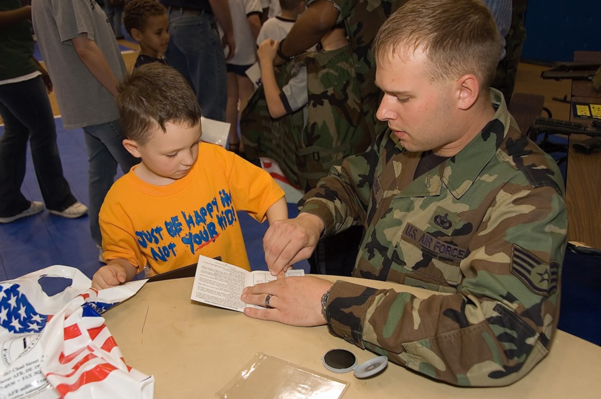 Noah Decker is fingerprinted by Staff Sgt. Michael Kohne, 436th Security Forces Squadron, at the Children's Deployment Line at the Youth Center April 19. (U.S. Air Force photo by Roland Balik)