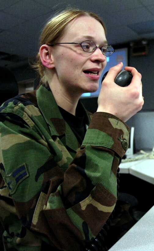 Airman 1st Class Corina Arangure talks from the 789th Communications Squadron's Centralized Network Control Station at Andrews Air Force Base, Md., with an operator at Airfield Portugal. Airman Arangure is a radio operator assigned to the CNCS.  (U.S. Air Force photo/Bobby Jones)