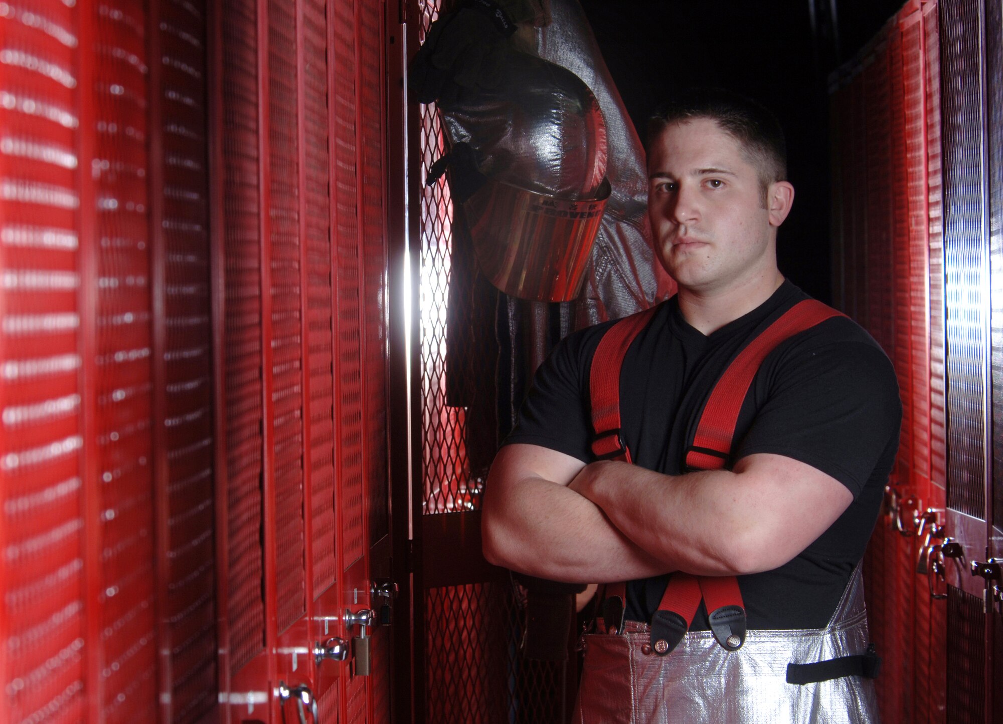 Senior Airman Christopher Provencal stands in the locker room of the fire station at Yokota Air Base, Japan, on Friday, April 28, 2006. He is with the 374th Civil Engineer Squadron. (U.S. Air Force photo/Val Gempis)