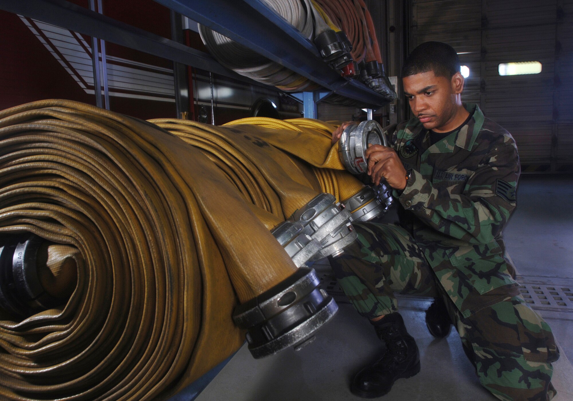 Staff Sgt. Gary Nunley inspects water hoses for defects at Yokota Air Base, Japan, on Friday, April 28, 2006. Sergeant Nunley is a firefighter with the 374th Civil Engineer Squadron. (U.S. Air Force photo/Val Gempis)
