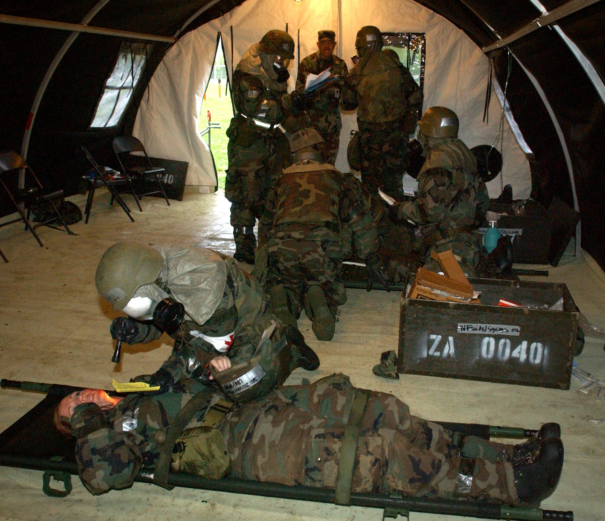 Airmen from the 31st Medical Group at Aviano Air Base, Italy, go through an exercise scenario during combat medical readiness training on Thursday, April 27, 2006. The training prepares Airmen for deployments and rapid response in emergency situations. (U.S. Air Force photo/Airman Liliana Moreno)