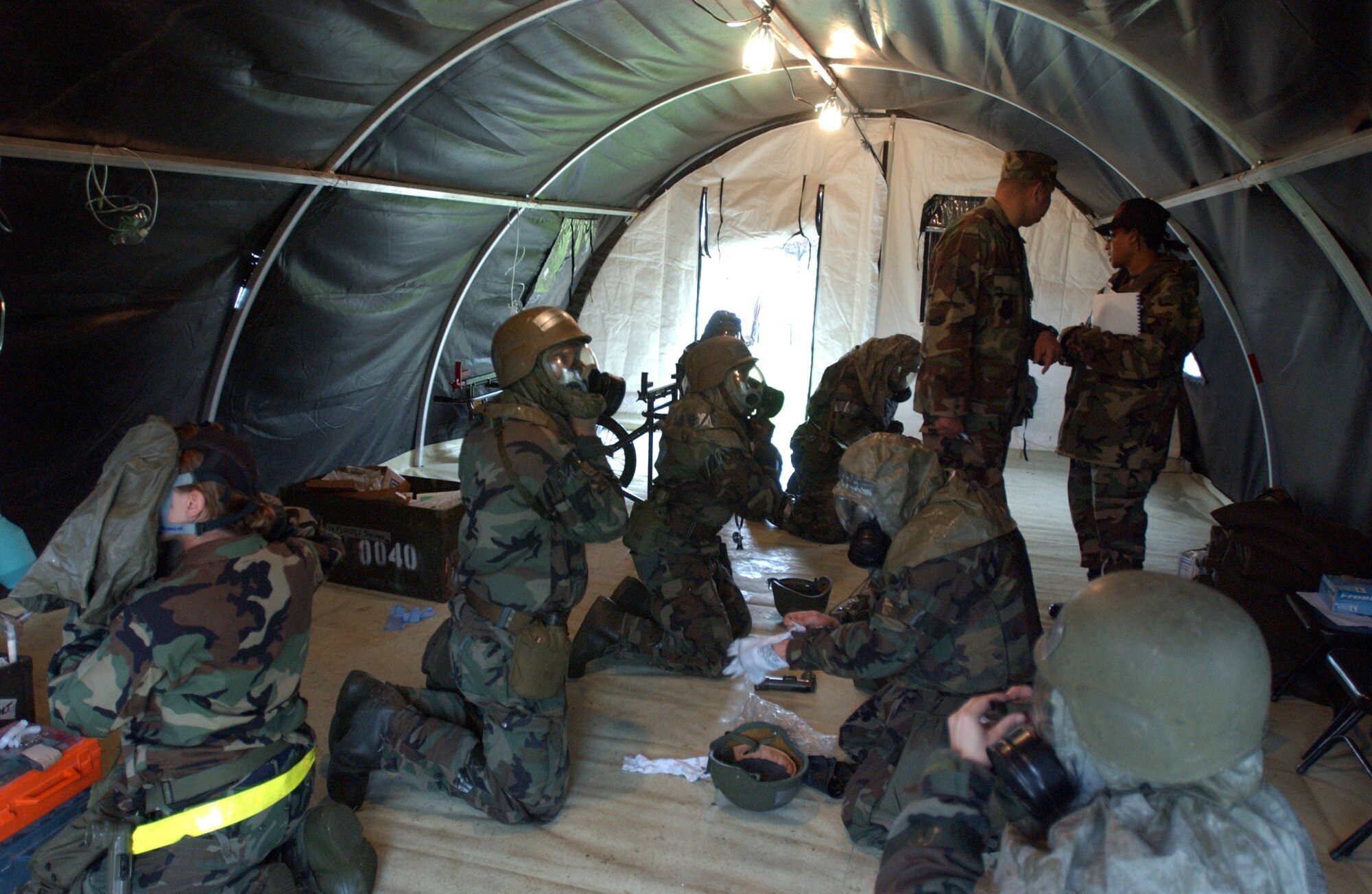 Airmen from the 31st Medical Group at Aviano Air Base, Italy, don chemical defense gear during combat medical readiness training on Thursday, April 27, 2006. The training prepares Airmen for deployments and rapid response in emergency situations. (U.S. Air Force photo/Airman Liliana Moreno) 