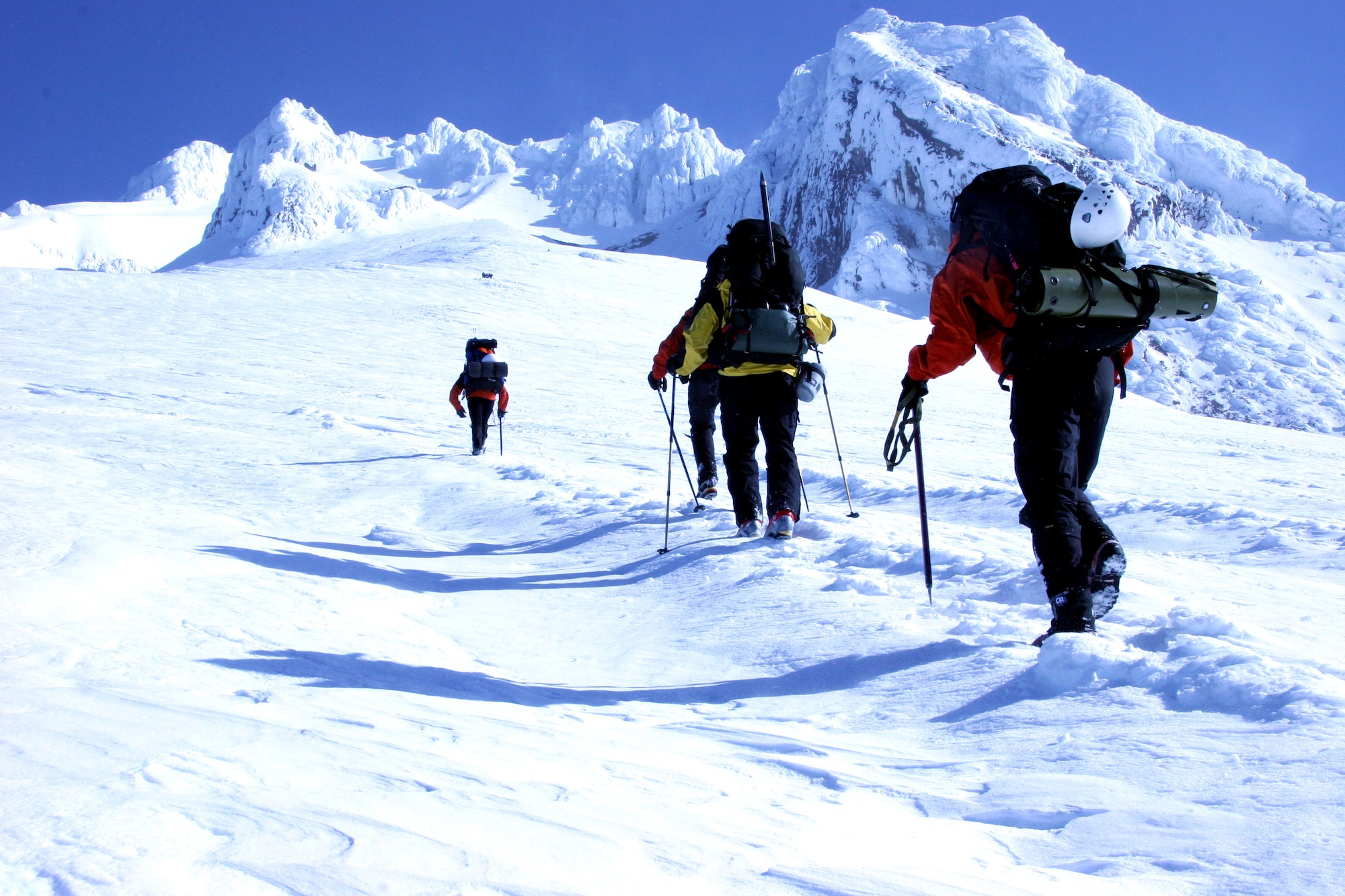 (Left to right) Master Sgts. Scott Light and Eric Giacchino, Tech. Sgt. John Davis and Capt. Quintin Nelson use ice axes and walking poles while searching for two "lost" climbers on Mount Hood, Ore., on Saturday, April 22, 2006. The Airmen are from the Air Force Reserve Command's 304th Rescue Squadron, and were participating in a search and rescue exercise with five local civilian organizations. (U.S. Air Force photo/Ruby Zarzyczny)
