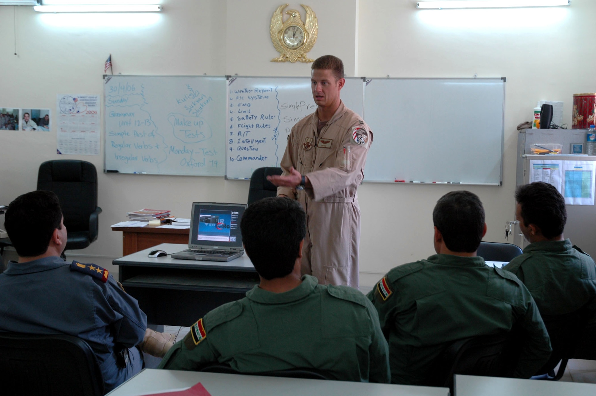 Capt. Anthony Brim instructs Iraqi Air Force pilots at Kirkuk Air Base, Iraq, on Sunday, April 30, 2006. Captain Brim is a member of the Coalition Air Force Transition Team, helping the Iraqi 3rd Squadron in developing operational capabilities. (U.S. Air Force photo/Staff Sgt. Kristina Barrett)