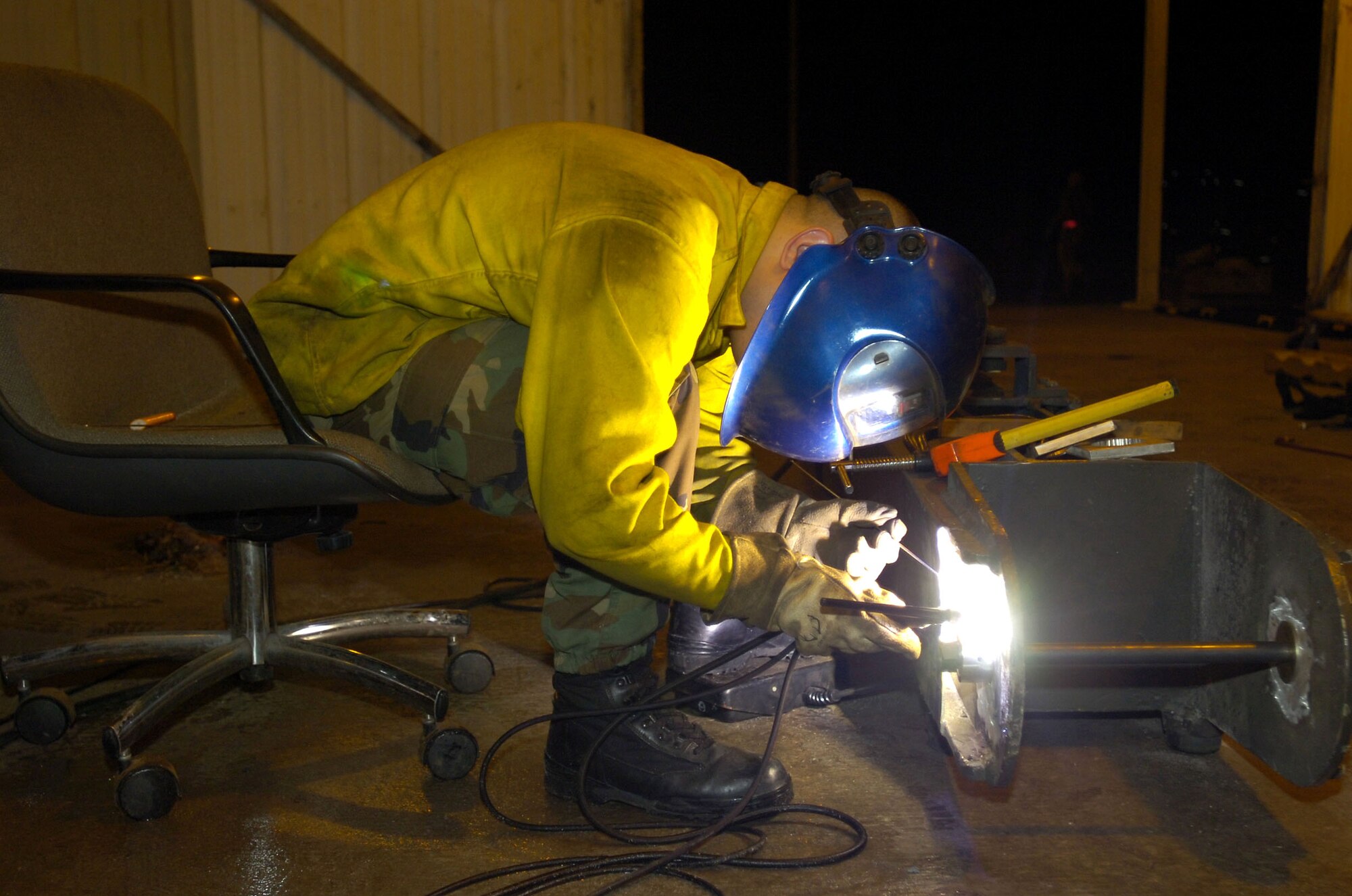 Staff Sgt. Jeremy Manley welds a plate on a tow bar used on B-52 Stratofortresses. Sergeant Manley, deployed from Barksdale Air Force Base, La., is assigned to the 40th Expeditionary Maintenance Squadron in Southwest Asia. (U.S. Air Force photo/Senior Master Sgt. John Rohrer) 