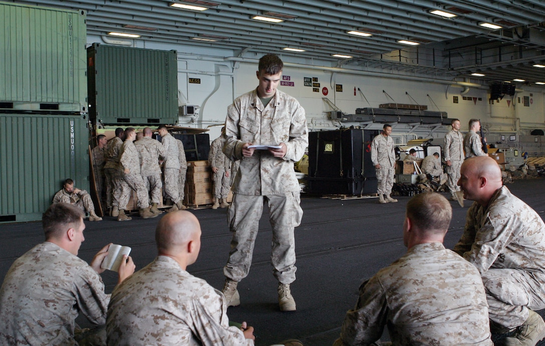 Cpl. Paul C. O'Donnell, an anti-tank guided missleman with Weapons Company, Battalion Landing Team, 1st Battalion, 8th Marine Regiment, 24th Marine Expeditionary Unit, teaches a class on Arabic language skills in the hangar bay of the USS Iwo Jima on May 3, 2006.  Currently, the 24th MEU is working toward earning its Special Operations Capable or SOC designation during its Certification Exercise.