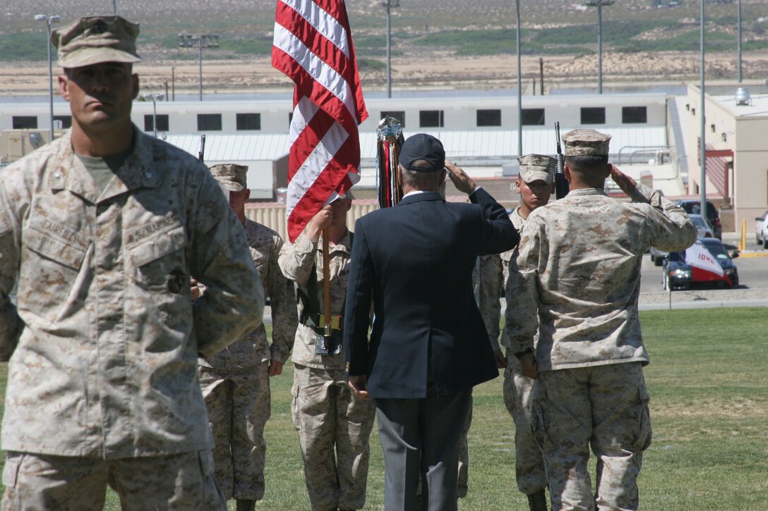 Retired Lt. Col. William C. Vielhauer, former executive officer and commanding officer of the 11th Marine Regiment, and Cpl. Ruben Baldernero, artilleryman with 3rd Battalion, 11th Marine Regiment, place the Korean Service Streamer with four Bronze Stars on the battalion colors as the 3/11?s commanding officer, Lt. Col. Douglas H. Fairfield, stands at parade rest in front of the battalion colors May 4 during 3/11?s colors rededication ceremony at the Combat Center parade field.
