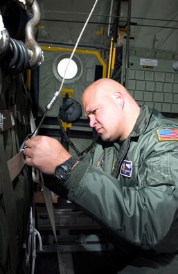 Tech. Sgt. Chuck Brynteson secures container delivery systems in a C-130 Hercules at Elmendorf Air Force Base, Alaska, as part of Red Flag-Alaska 06-2 exercises on Friday, April 28, 2006. Sergeant Brynteson is with the 96th Airlift Squadron at Minneapolis-St. Paul Joint Air Reserve Station, Minn. (U.S. Air Force photo/Senior Airman Garrett Hothan)