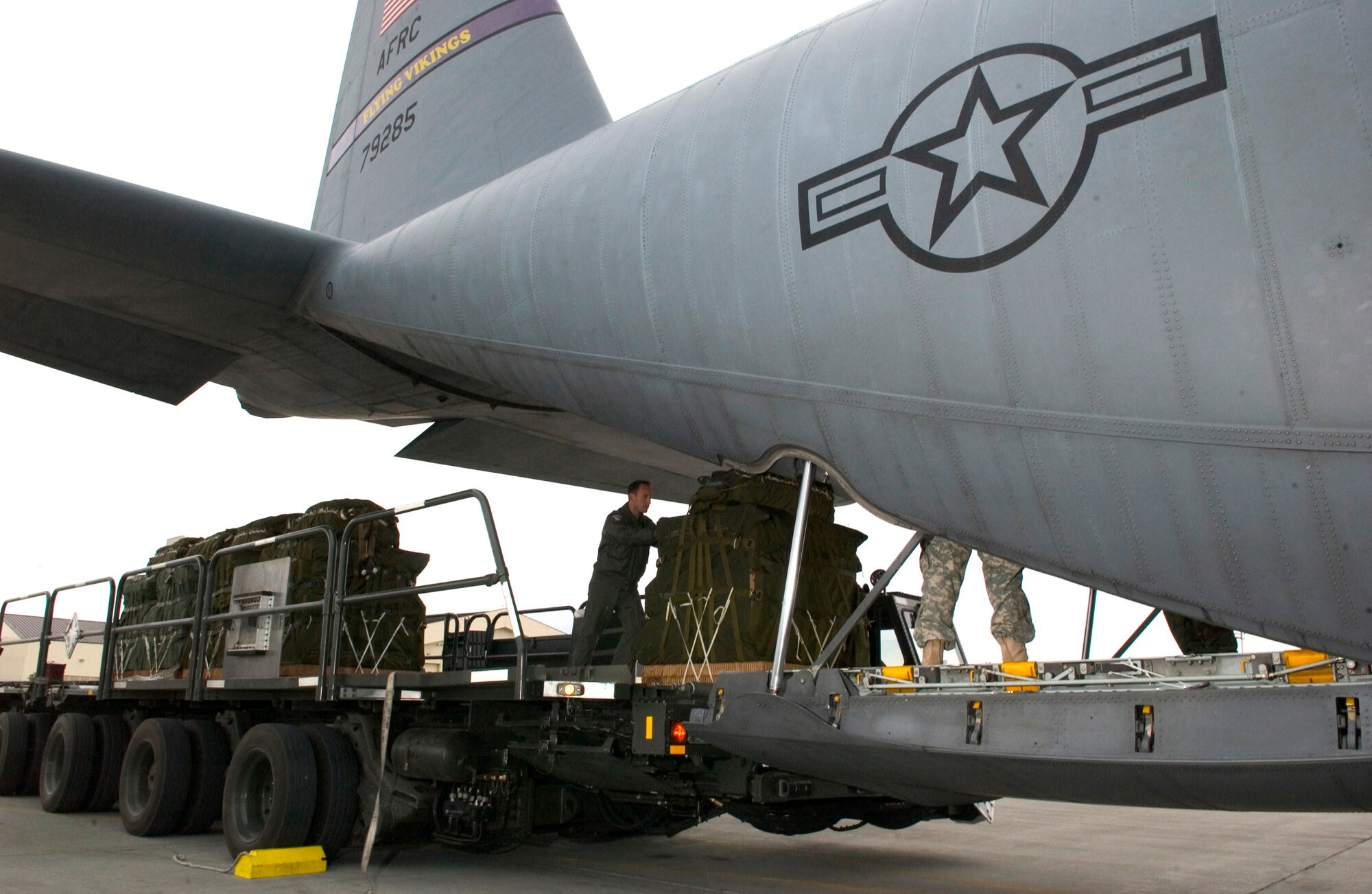 Master Sgt. Brad Cooper loads container delivery systems onto a C-130 Hercules at Elmendorf Air Force Base, Alaska, as part of Red Flag-Alaska 06-2 exercises on Friday, April 28, 2006. Sergeant Cooper is with the 96th Airlift Squadron at Minneapolis-St. Paul Joint Air Reserve Station, Minn. (U.S. Air Force photo/Senior Airman Garrett Hothan)