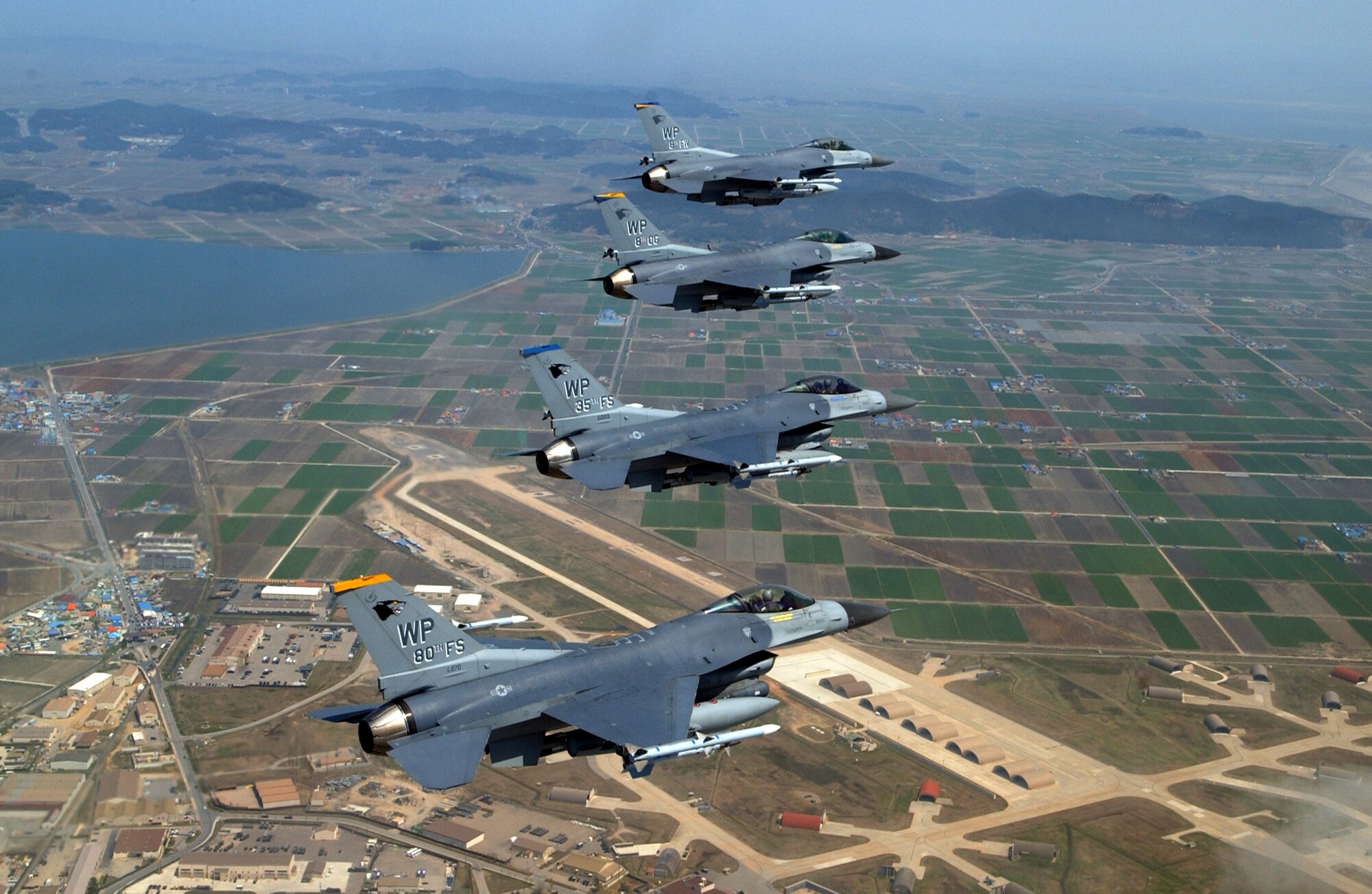 A formation of F-16 Fighting Falcons from the 8th Fighter Wing at Kunsan Air Base, South Korea, flies in close formation near the base on Friday, April 28, 2006. The formation was led by Col. Brian Bishop, 8th FW commander. (U.S. Air Force photo/Master Sgt. Richard Freeland)