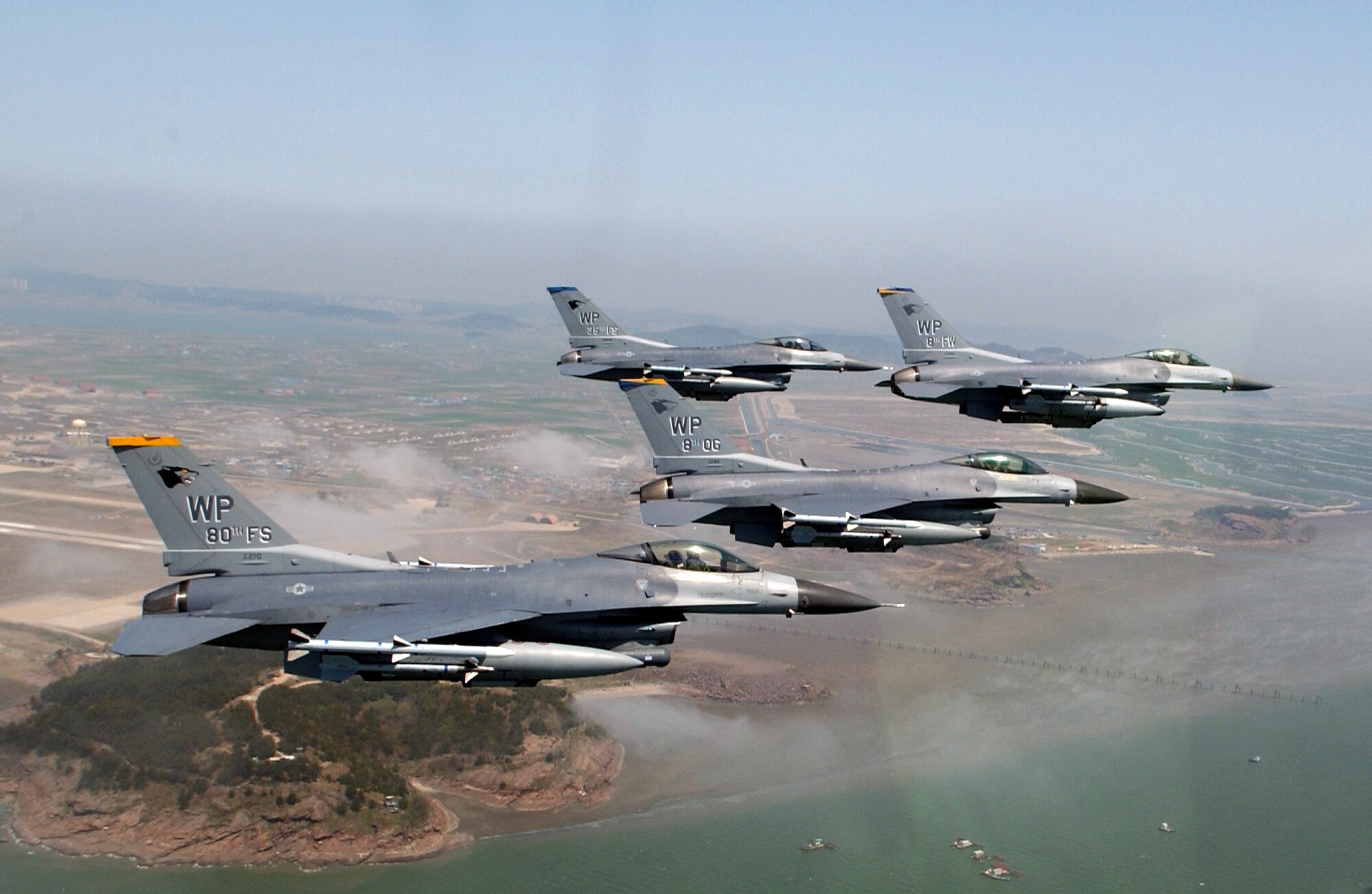 A formation of F-16 Fighting Falcons from the 8th Fighter Wing at Kunsan Air Base, South Korea, flies in close formation near the base on Friday, April 28, 2006. The formation was led by Col. Brian Bishop, 8th FW commander. (U.S. Air Force photo/Master Sgt. Richard Freeland) 