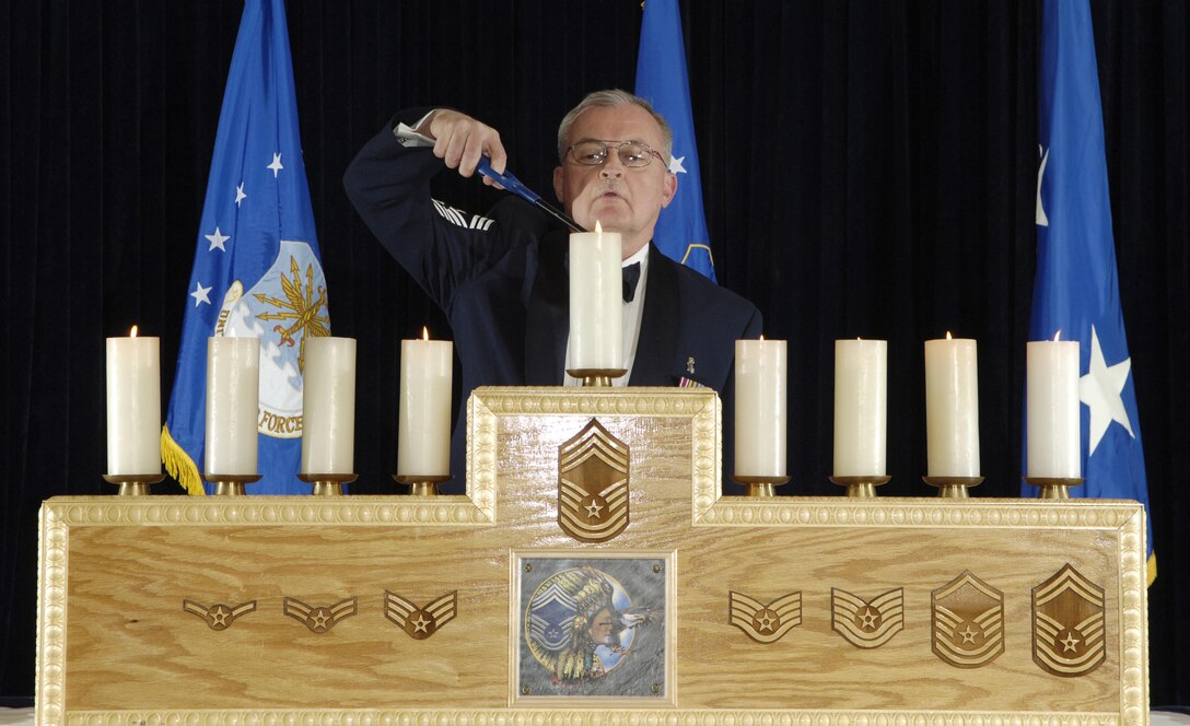 Chief Master Sgt. Richard A. Smith of the Air National Guard lights the final candle in a joint Reserve/ANG chief master sergeant induction ceremony held recently at the Collocated Club on McGuire Air Force Base, N.J. 