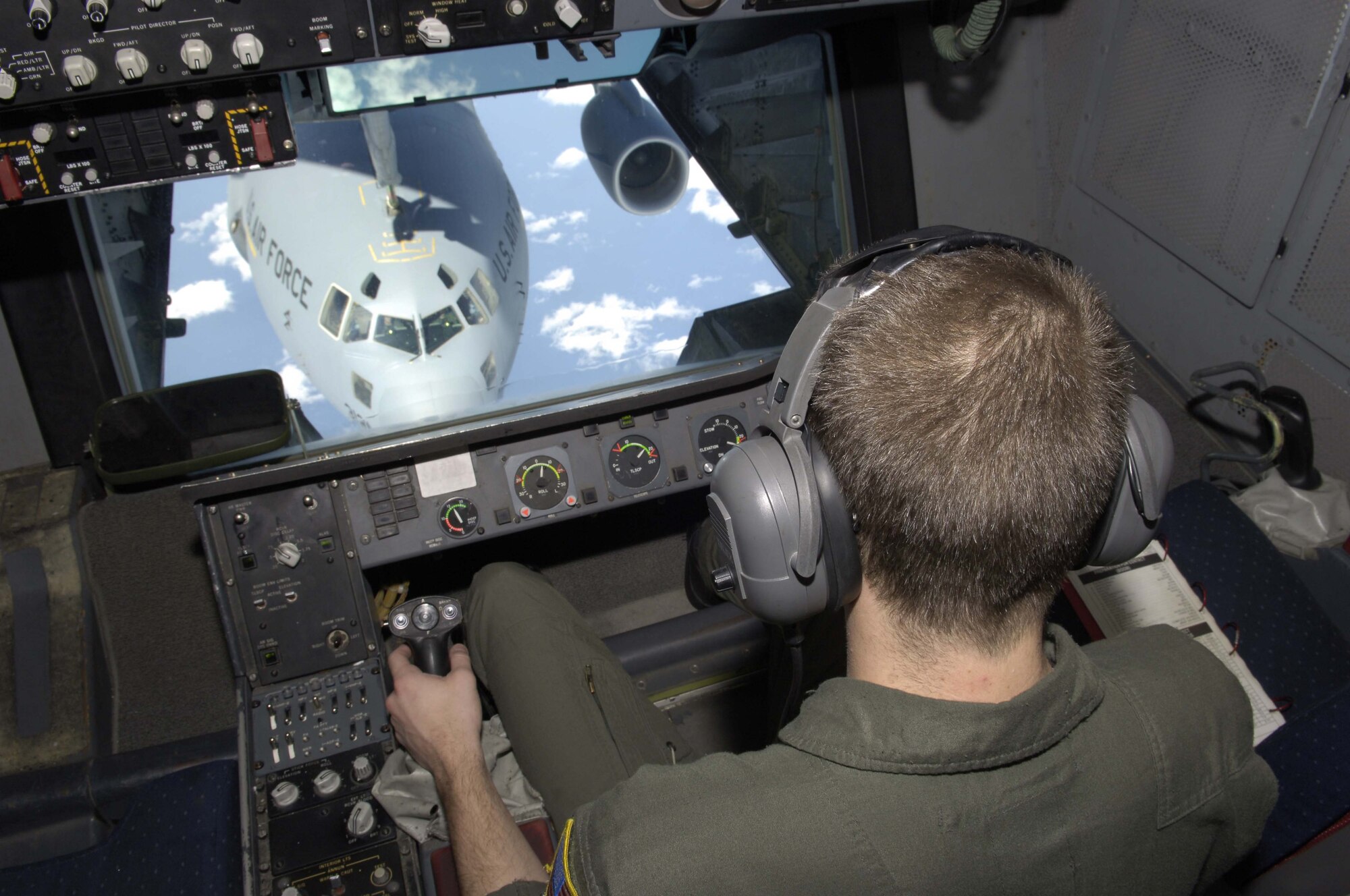 Airman First Class Rick Taylor, a Reserve boom operator with the 78th Aerial Refueling Squadron at McGuire Air Force Base, N.J., refuels a C-17 Globemaster III. The flight was also part of a fini-flight for Airman Taylor's father, Senior Master Sergeant Rick Taylor, a boom operator with the 32nd Aerial Refueling Squadron and the longest serving boom operator in active duty. During the flight Sergeant Taylor will refuel his son's aircraft and then Airman Taylor will refuel his father's aircraft. This mission took place on April 17, 2006. U.S. Air Force photo by Scott H. Spitzer