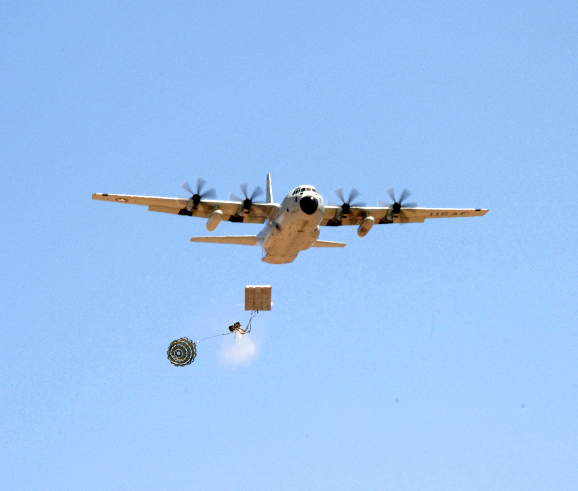 A Type 5 heavy pallet is extracted from a C-130J Hercules flying over Edwards Air Force Base, Calif., on Sunday, April 30, 2006. The mission was part of a test to certify the aircraft's capability to drop this type of pallet. Guard, Reserve and active-duty aircrews from Channel Islands Air National Guard Base, Calif.; Little Rock AFB, Ark.; and Keesler AFB, Miss., participated in the certification. This was the first time the "J" model dropped a Type 5 pallet. (U.S. Air Force photo/Tech. Sgt. Dave Buttner)
