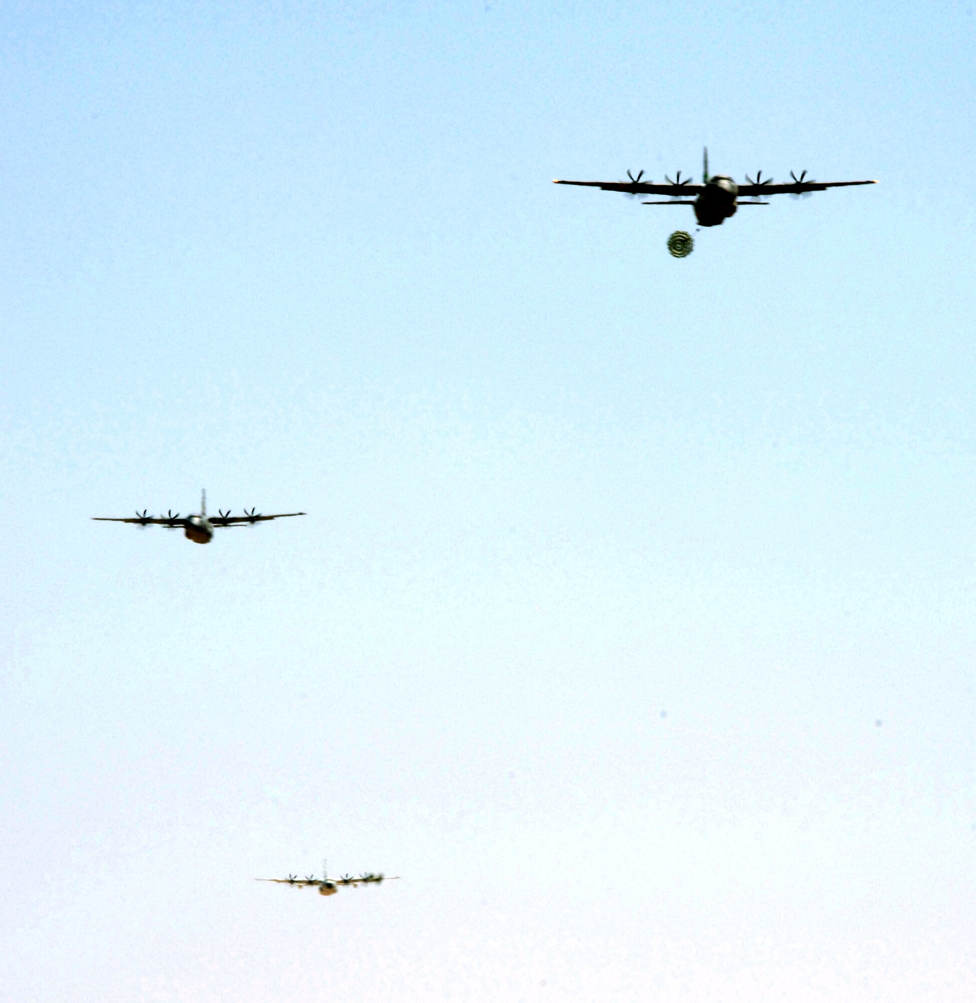 C-130J Hercules aircraft fly over Edwards Air Force Base, Calif., on Sunday, April 30, 2006, during a mission to test and certify the aircraft's capability to drop the Type 5 heavy pallet. It is the first time the "J" model has dropped these type pallets, known as "heavies." Guard, Reserve and active-duty aircrews from Channel Islands Air National Guard Base, Calif.; Little Rock AFB, Ark.; and Keesler AFB, Miss., participated in the mission. (U.S. Air Force photo/Tech. Sgt. Dave Buttner)