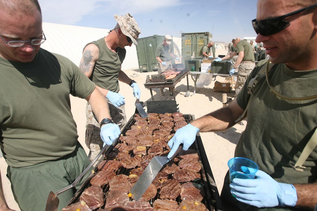 Marine Corps Air Ground Combat Center, Twentynine Palms, Calif. -- Senior enlisted service members grill marinated steak with pineapple at 3rd Battalion, 2nd Marine Regiment's barbecue dinner here May 3. The unit's senior enlisted put on the event for Marines and Sailors as a reward training hard at the Marine Corps' top pre-deployment desert training called Mojave Viper. Steaks with pineapple, hot dogs and hamburgers were some of the things served there. The unit will deploy with his unit later this year.