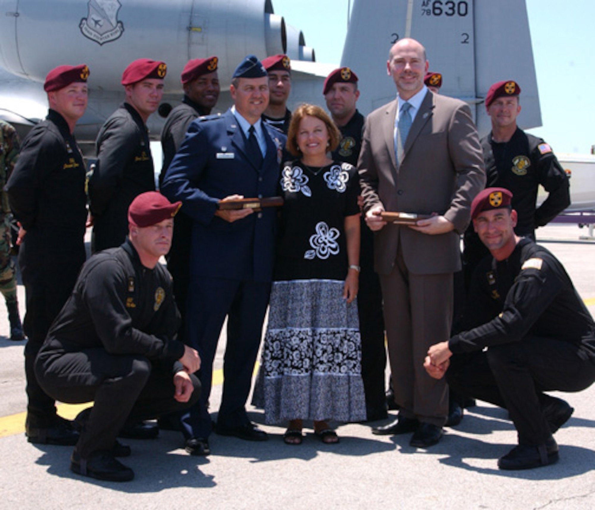 Air Force Reserve Col. Randy Falcon, center left, Commander of the 482d Fighter Wing, Homestead Air Reserve Base, Florida, is shown with the U.S. Army's Golden Knights parachute demonstration team after being awarded the Golden Baton award from the team. The Golden Knights are the Army's premier parachute demonstration team and perform at events worldwide.  (U.S. Air Force photo by Master Sgt Ray Sarracino)  