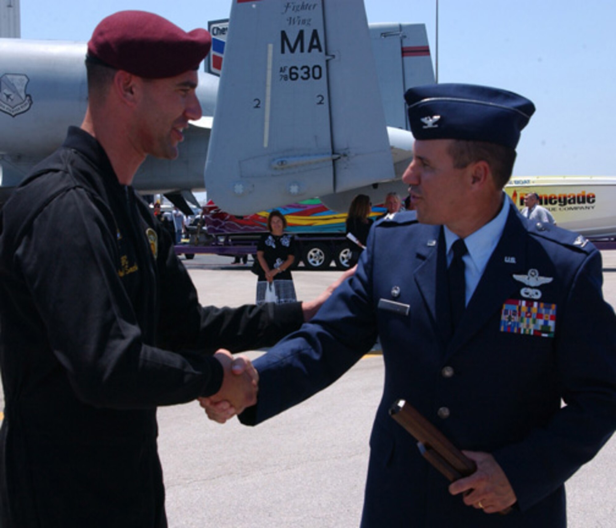 Air Force Reserve Col. Randy Falcon, right, Commander of the 482d Fighter Wing, Homestead Air Reserve Base, Florida, receives the Golden Baton award from Sergeant First Class Paul Sachs, Team Leader of the Golden Knights. The Golden Knights are the Army's premier parachute demonstration team and perform at events worldwide.   (U.S. Air Force photo by Master Sgt Ray Sarracino)  