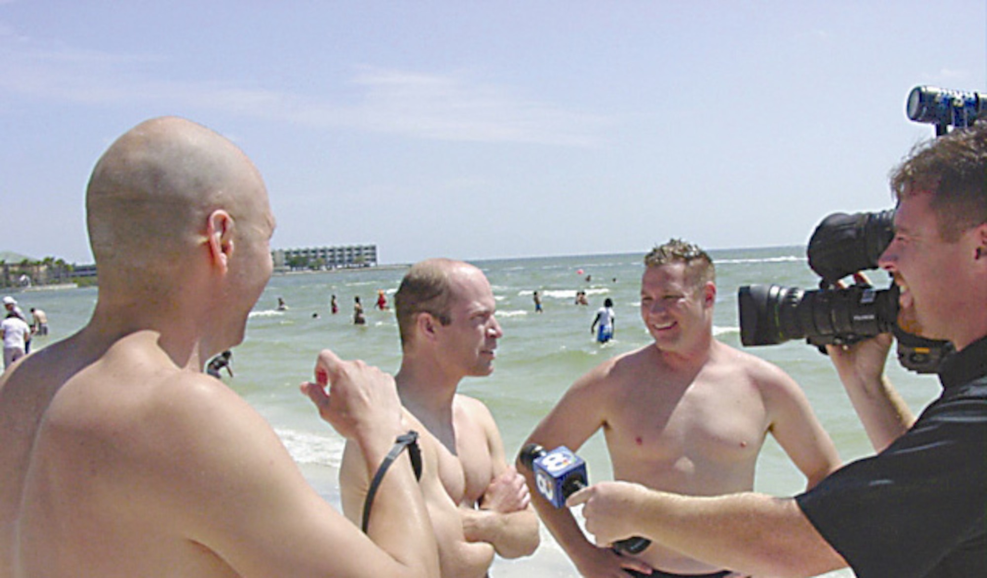 Doug Gale, of Beavercreek, Ohio,  Chris Zingarelli, of National Air and Space Intelligence Center, and Jay Wilkerson, of Air Force Institute of Technology, are interviewed by a local reporter here after setting a new relay record April 22 at the Tampa Bay Marathon Swim. (Air Force photo by Jack Bazure)
