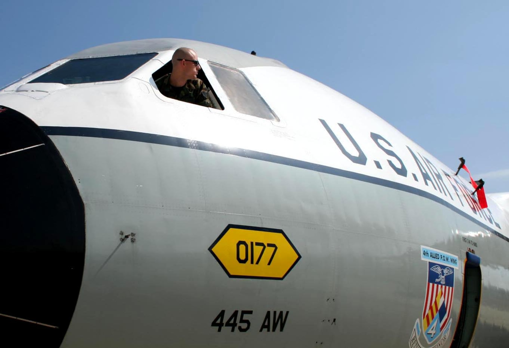 Senior Airman Christopher Braun, a reservist with the 445th Aircraft Maintenance Squadron at Wright-Patterson Air Force Base, Ohio, controls the stick of this C-141 Starlifter, also known as the "Hanoi Taxi," as it is pushed by a maintenance tug.  The aircraft is set for retirement and dedication at the National Museum of the United States Air Force in Dayton, Ohio, on May 6.  (U.S. Air Force photo/Senior Airman Kenny Kimbrell)