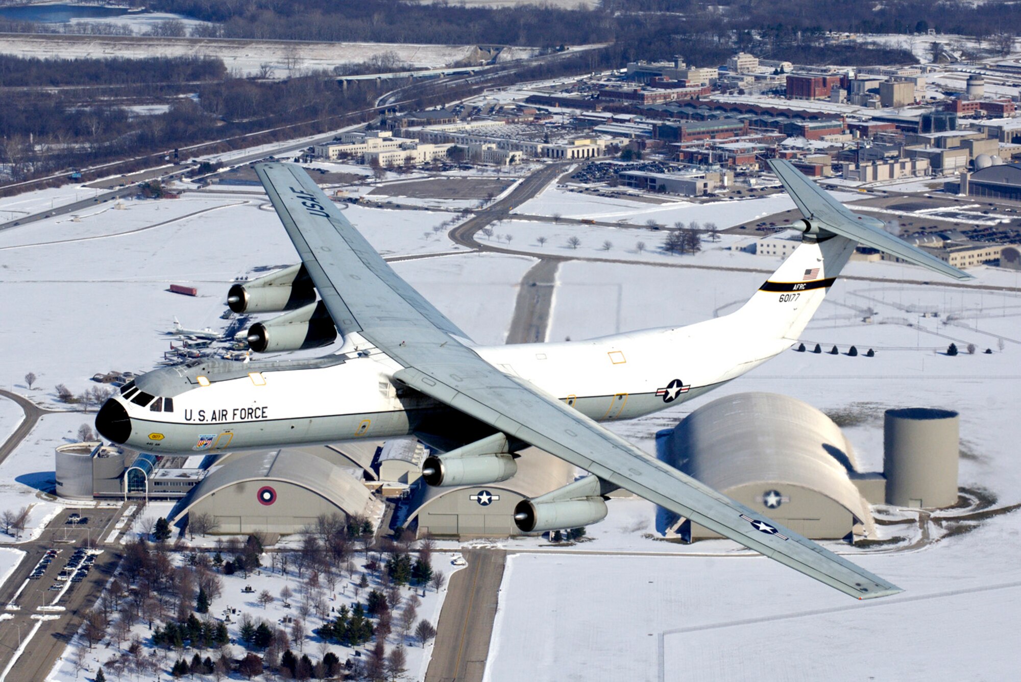 This C-141 Starlifter aircraft, known as the "Hanoi Taxi," flies over its soon-to-be new home at the National Museum of the United States Air Force adjacent to Wright-Patterson Air Force Base, Ohio, on Tuesday, Dec. 13, 2005.  This particular aircraft gained fame when it was used to return American prisoners of war back home at the end of the Vietnam War.  The aircraft is set for retirement and dedication at the National Museum of the United States Air Force in Dayton, Ohio, on May 6.  (U.S. Air Force photo/John Rossino)