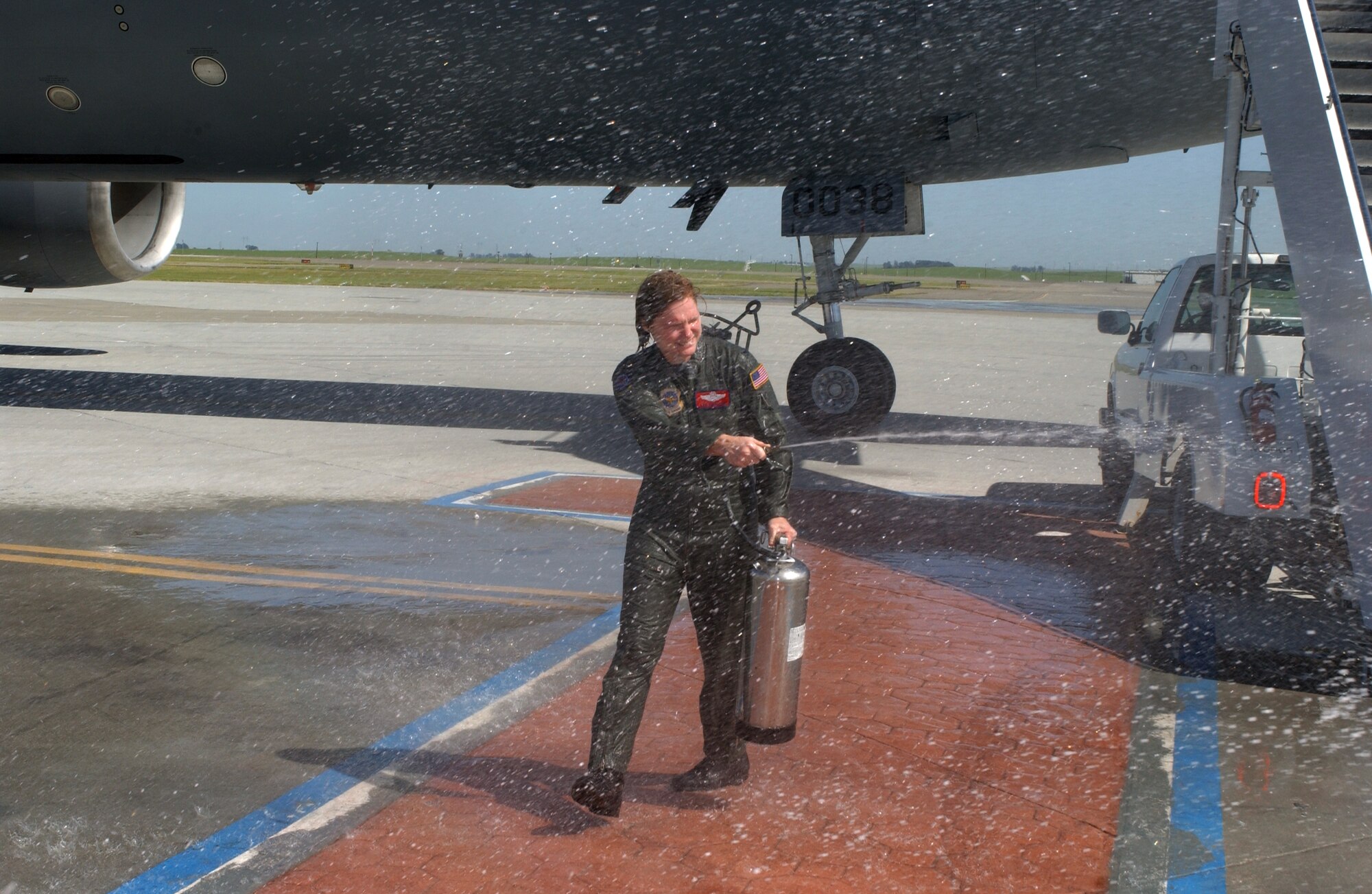 Col. Lyn Sherlock, 60th Air Mobility Wing commander, takes control of the hose after her fini flight Monday. (U.S. Air Force photo by Andre Mansour)
