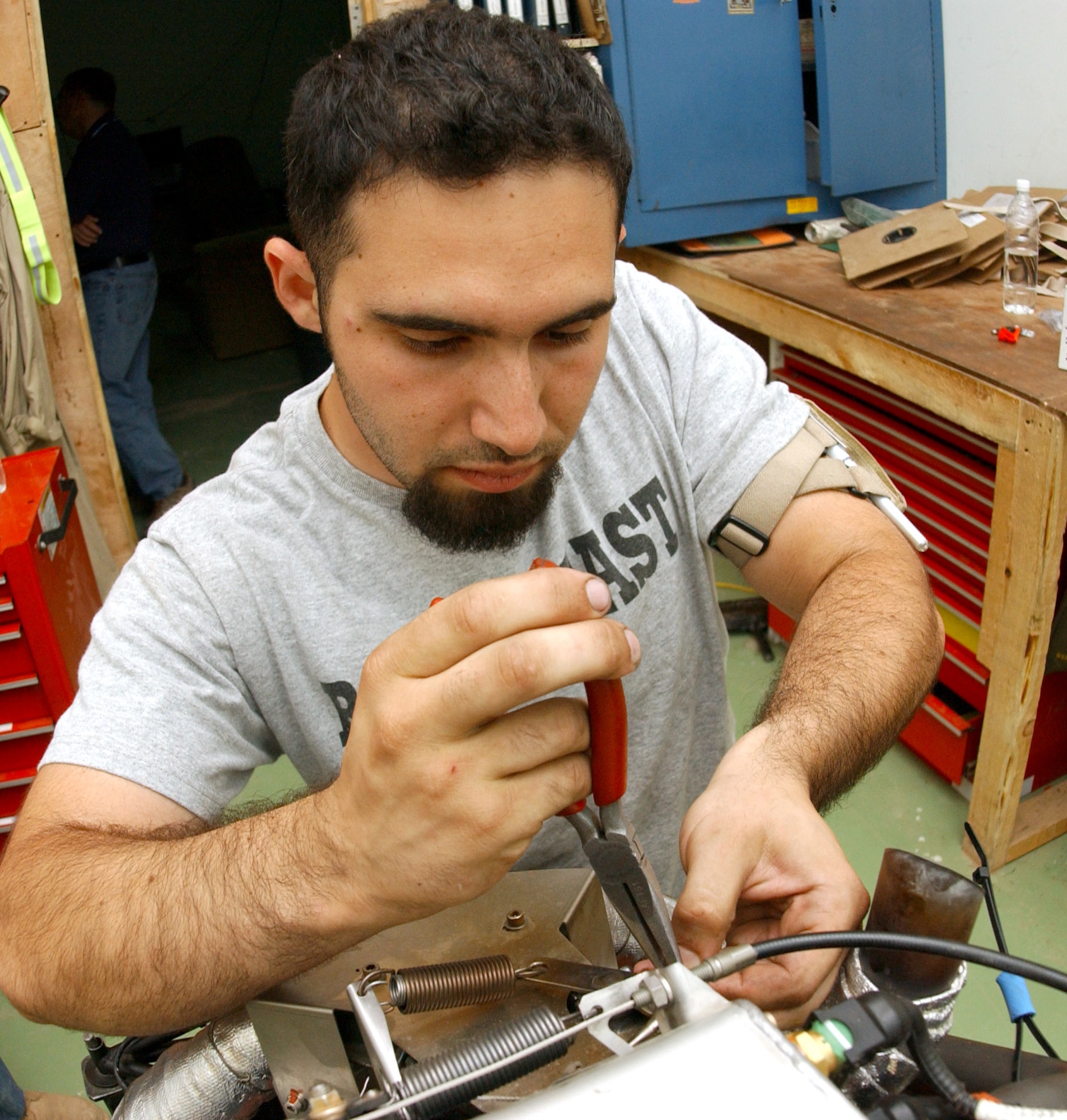 Robert Attard works on an engine from an RQ-1 Predator unmanned aerial vehicle. Mr. Attard is a contract maintainer assigned to the 46th Expeditionary Aircraft Maintenance Unit at Balad Air Base, Iraq. (U.S. Air Force photo/Airman 1st Class Jason Ridder)