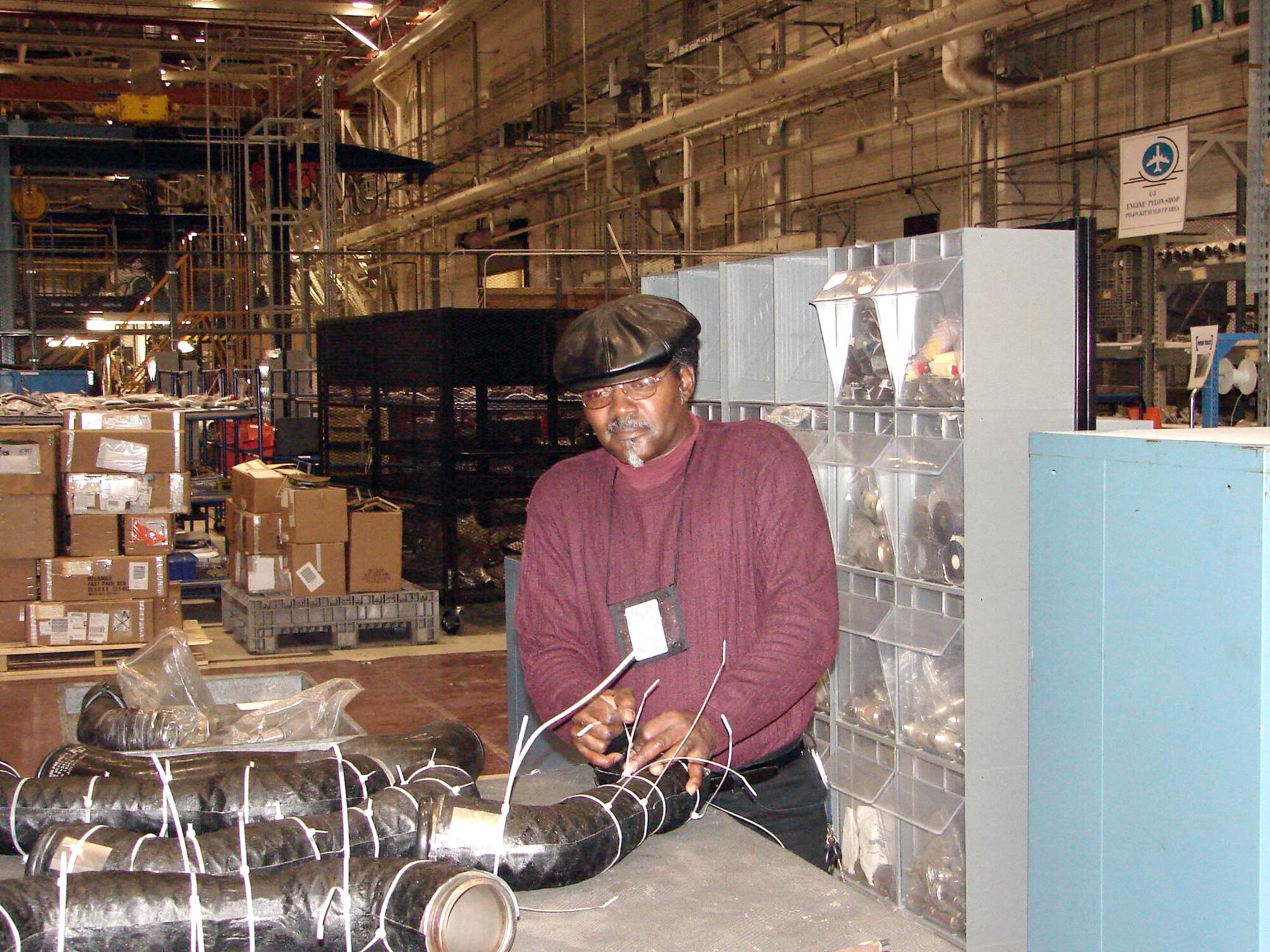 James Releford repairs the insulation on hot air ducts for C-5 Galaxy pylons. The Warner Robins Air Logistics Center at Robins Air Force Base, Ga., received the 2006 Franz Edelman Award for Achievement in Operations Research on Monday, May 1, 2006, for its use of operations research to streamline C-5 maintenance procedures. Using innovative management processes, the time required to repair and overhaul the aircraft was reduced 33 percent. Mr. Releford works in the center's C-5 pylon shop. (U.S. Air Force photo/James Morrow)