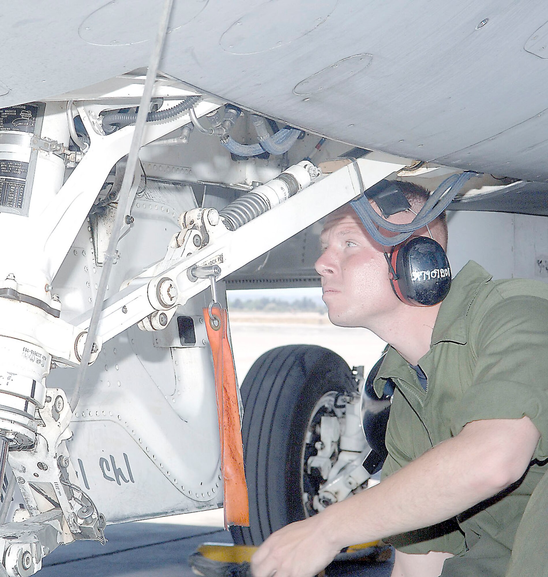 Staff Sgt. Jeremy Lewis, 79th Fighter Squadron crew chief, inspects landing gear on a jet. (U.S. Air Force Photo/Airman 1st Class Andrew Dumboski)