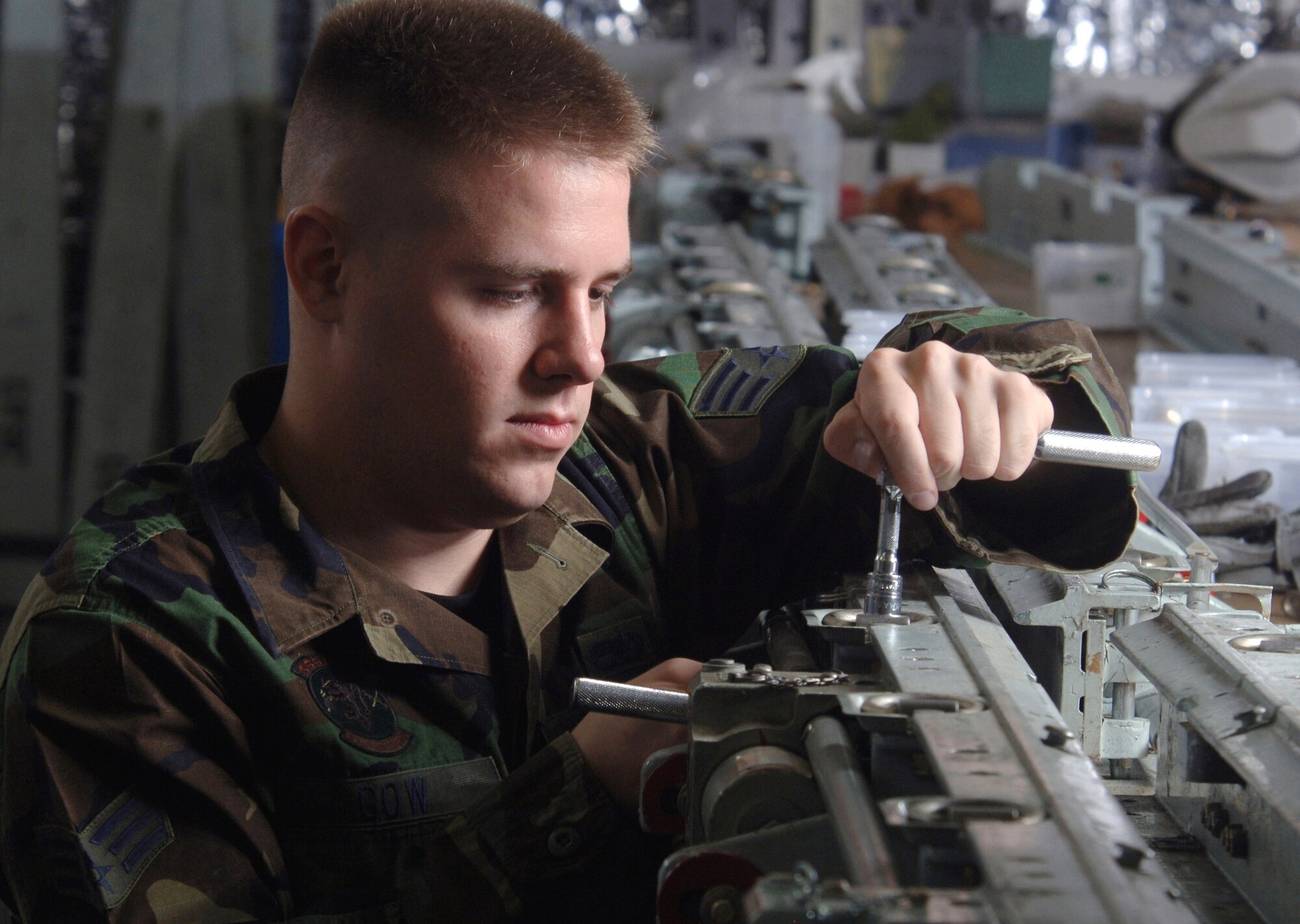 Senior Airman Christopher Gow checks a bolt on a D-ring of a C-130 Hercules cargo rail system during an inspection at Yokota Air Base, Japan, on Wednesday, May 3, 2006. The cargo handling system is inspected at least twice a year. Airman Gow is a C-130 crew chief with the 374th Aircraft Maintenance Squadron. (U.S. Air Force photo/Val Gempis)
