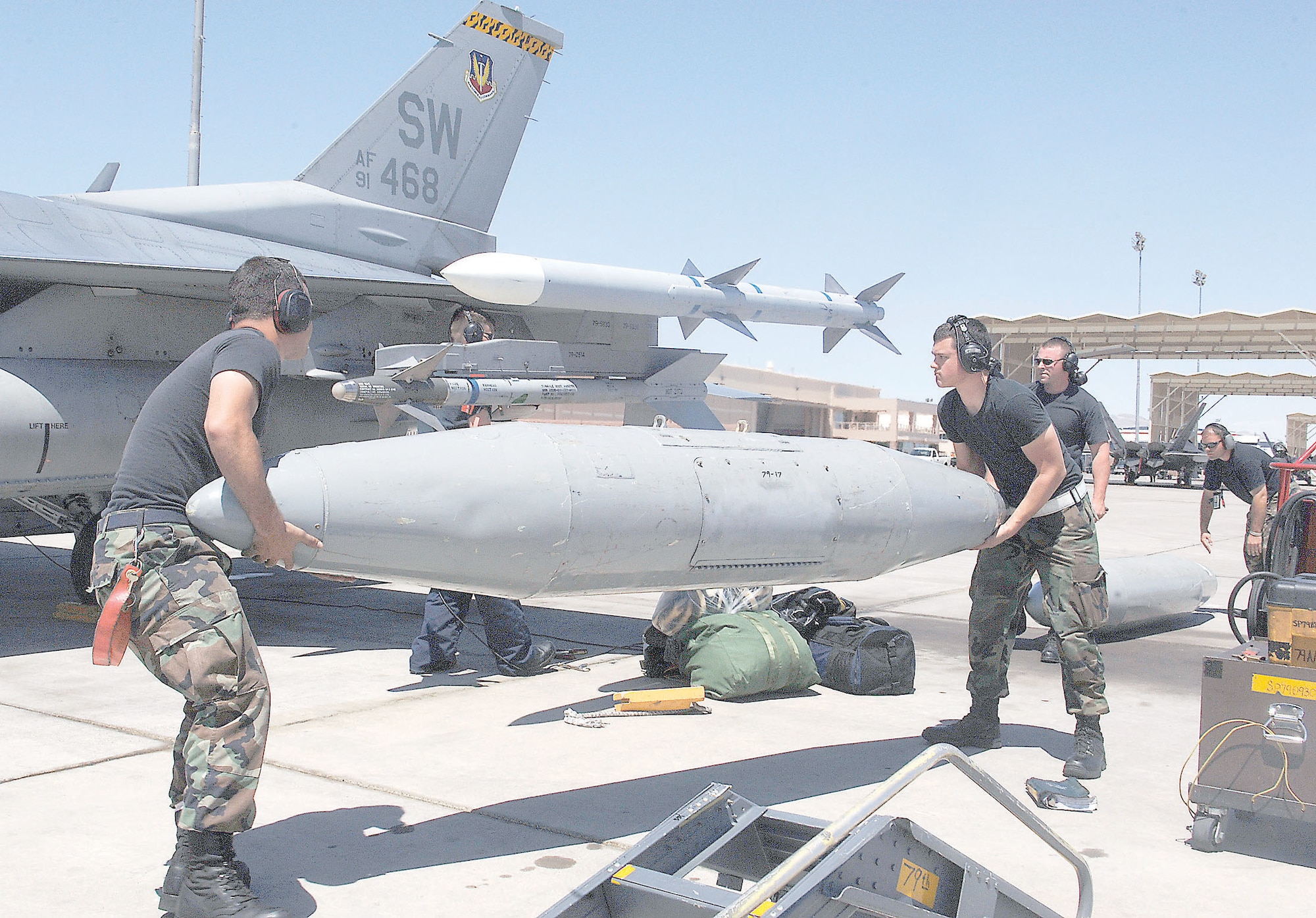 Shaw maintainers install a travel pod to a 79th Fighter Squadron jet in prepraration for its flight home.  The jet was one of 12 jets used to support the Weapons Instructor Course at Nellis Air Force Base, Nev. (U.S. Air Force Photo/Airman 1st Class Andrew Dumboski)