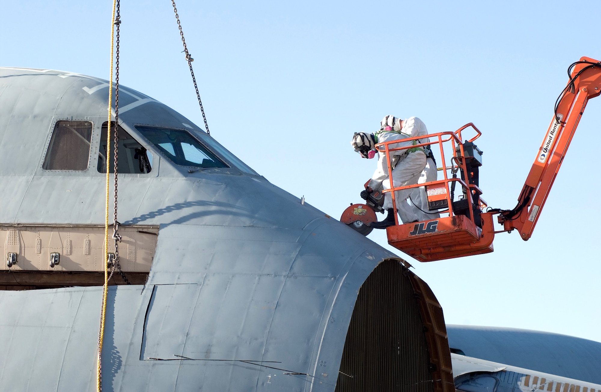 Two recovery team members remove pieces of the C-5 Galaxy which crashed at Dover Air Force Base, Del., April 3. (U.S. Air Force photo/Jason Minto)