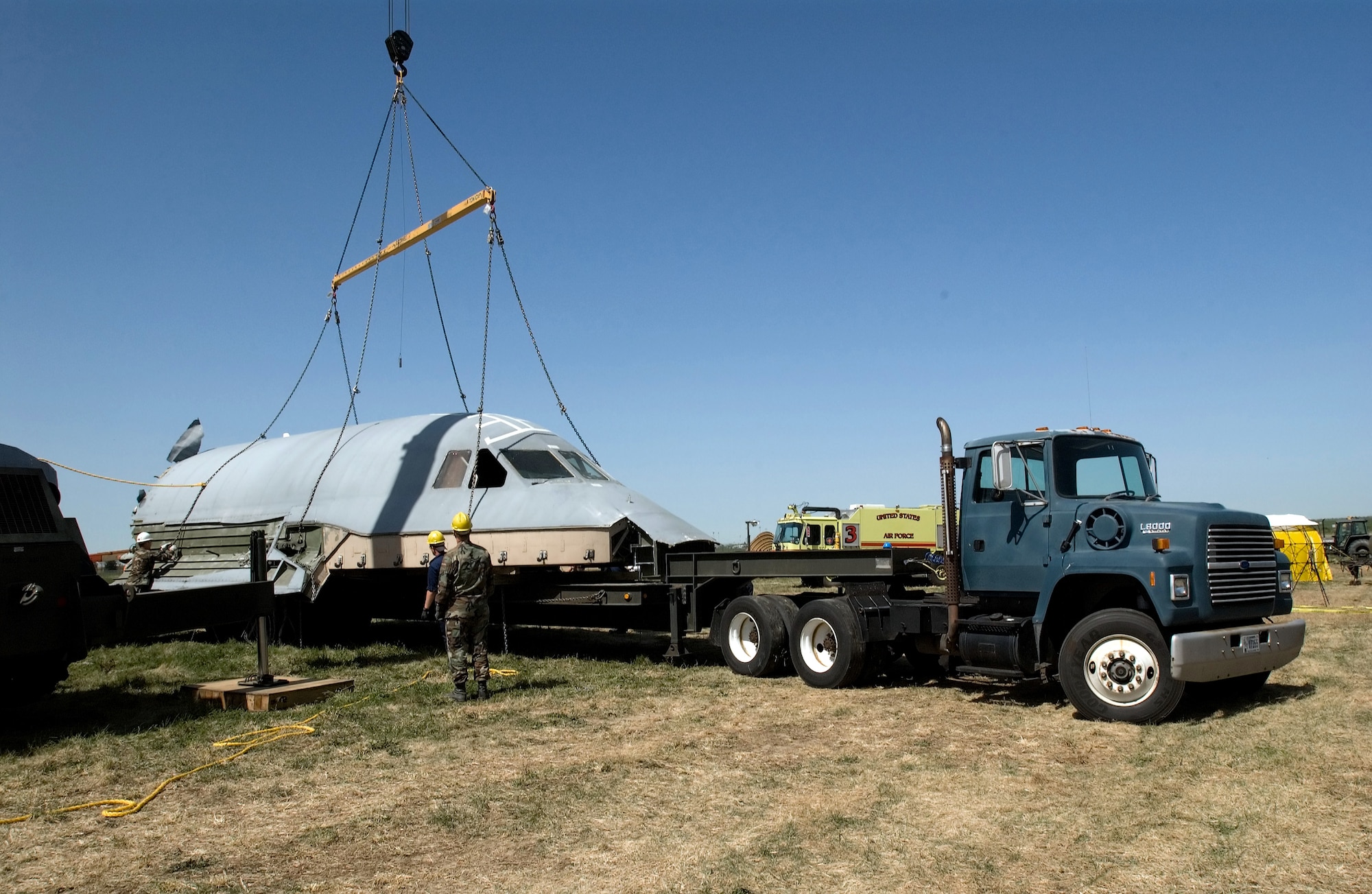 The crew compartment of the C-5 Galaxy that crashed at Dover Air Force Base, Del., April 3, is placed on a flatbed truck on Thursday, April 20, 2006. The compartment, once it is released by the accident investigation board, is expected to be used as a training simulator. (U.S. Air Force photo/Jason Minto) 