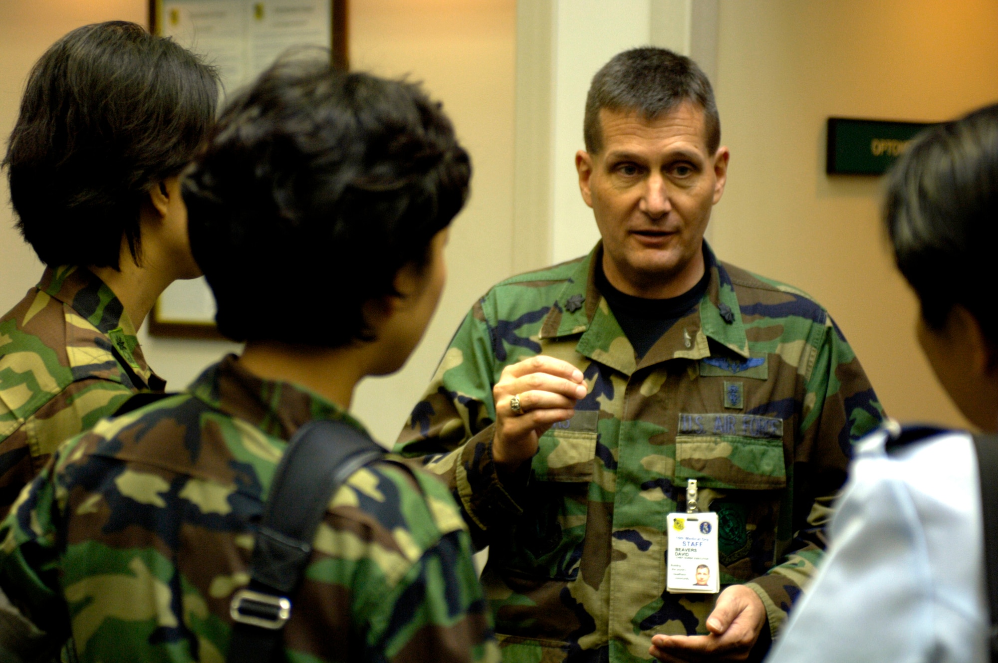 Lt. Col. David Beavers explains the operation of the William R. Schick Clinic to four visiting South Korean Air Force nurses at Hickam Air Force Base, Hawaii, on Tuesday, April 25, 2006. South Korea sent seven nurses to the island to discuss mass casualty response, civil-military coordination and biohazard response procedures for natural disaster management. The colonel is the chief nurse at the clinic and is assigned to the 15th Medical Group. (U.S. Air Force photo/Tech. Sgt. Shane A. Cuomo)