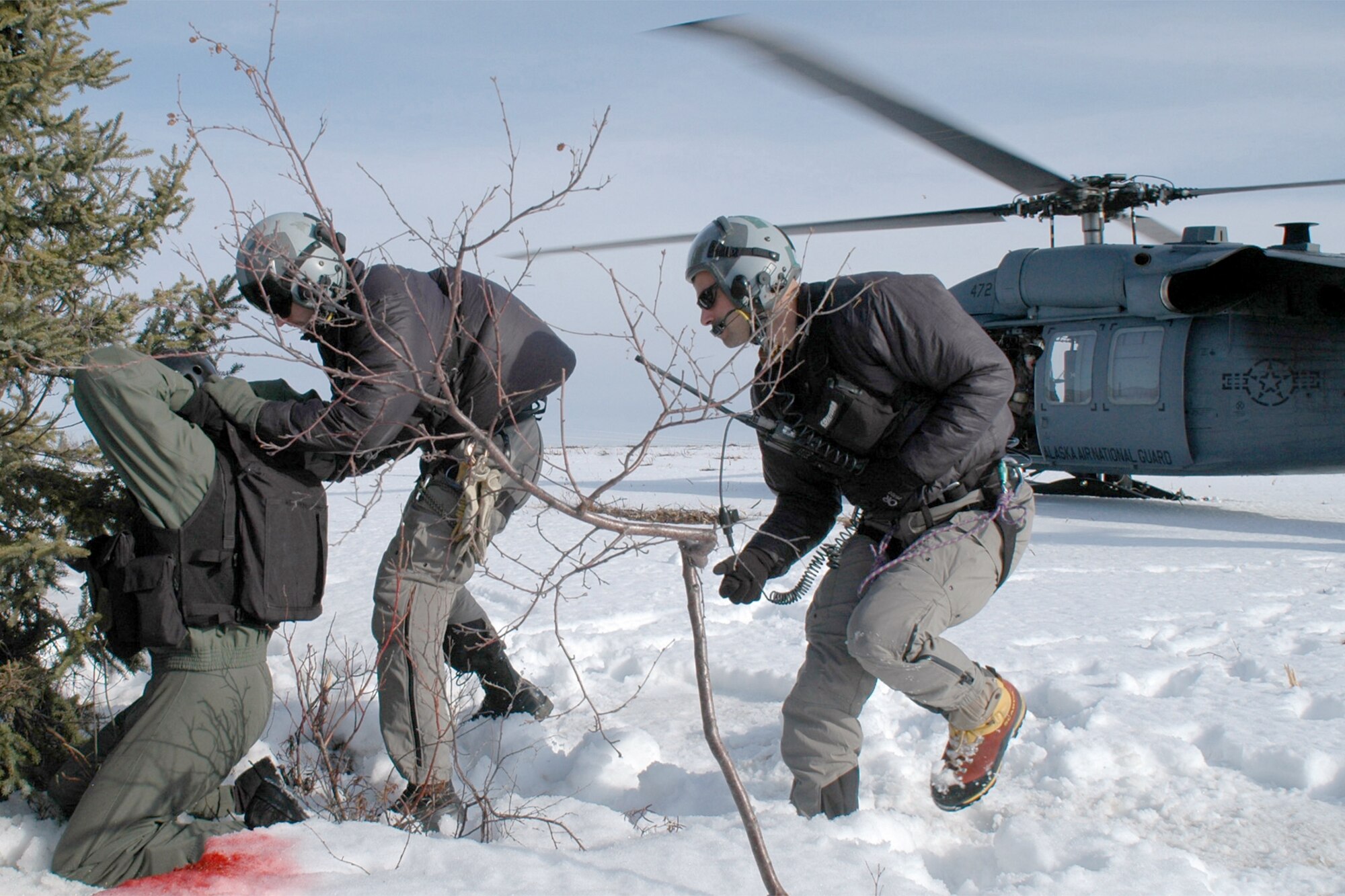 Capt. Ryan Pumford is "authenticated" by pararescuemen from the 210th Rescue Squadron at Eielson Air Force Base, Alaska, on Thursday, May 4, 2006, as part of Red Flag-Alaska 06-2.  An HH-60G Pave Hawk waits to take them out of a "hostile" area during the combat search and rescue training exercise.  (U.S. Air Force photo/Tech Sgt. Jeff Walston) 
