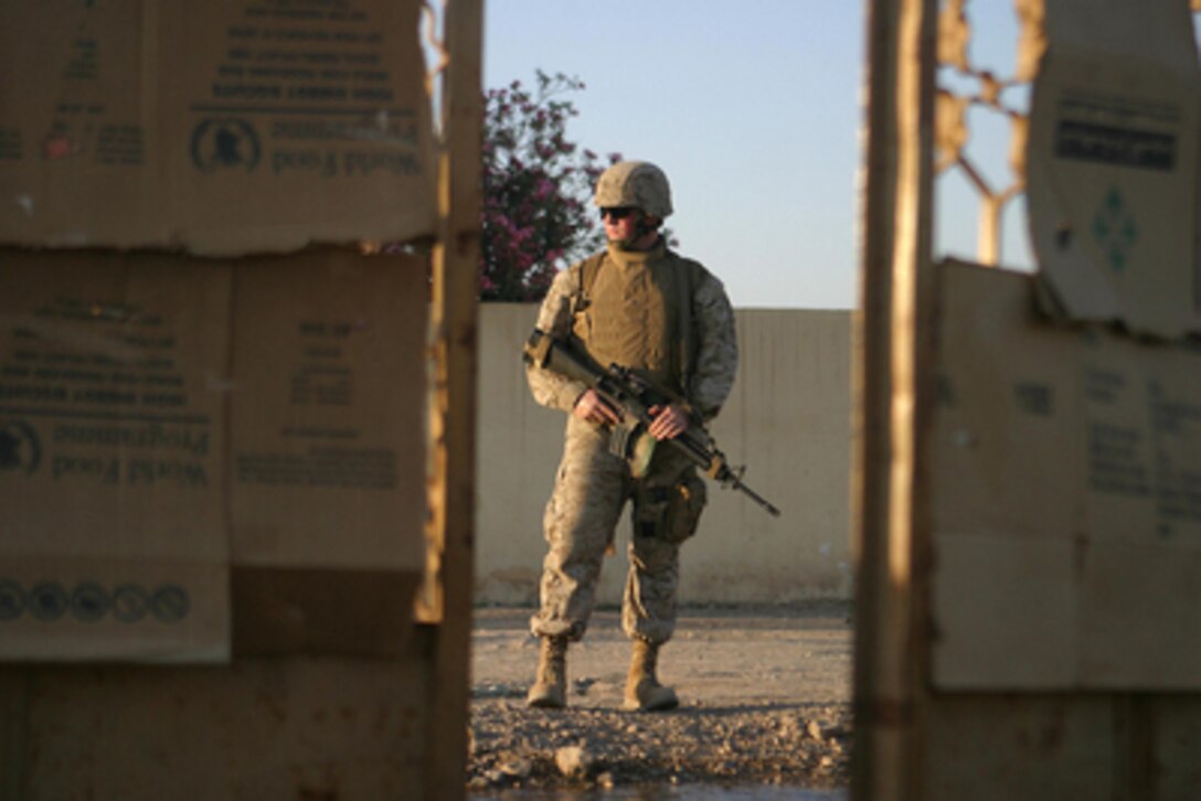 U.S. Marine Corps Lance Cpl. Matt Delaney focuses down the street as he patrols a neighborhood Al Ish, Iraq, on April 27, 2006. Delaney is attached to Weapons Company, 1st Battalion, 7th Marines. 