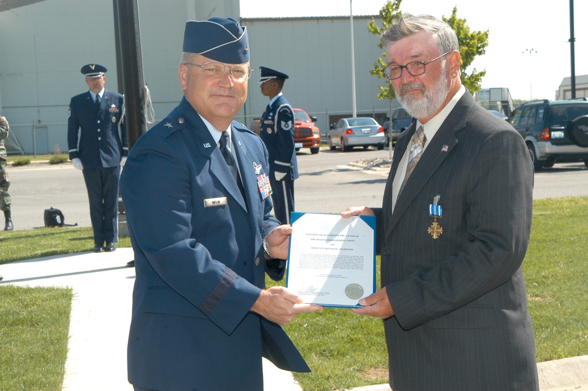 Ronald Sharpless of Galveston, Ind., is presented the Distinguished Flying Cross from Brig. Gen. James Melin, 434th Air Refueling Wing Commander. In 1968, as Sergeant Sharpless, he distinguished himself by extraordinary achievement while participating in a mission as an EC-47 Airborne Radio Operator near Ban Me Thuot, Republic of Vietnam on Aug. 9, 1968. He was given the certificate, but never presented the medal. General Melin, and members of the 434th ARW, honored Mr. Sharpless during a special ceremony May 6 at Grissom. (U.S. Air Force photo/ Tech. Sgt. Doug Hays)