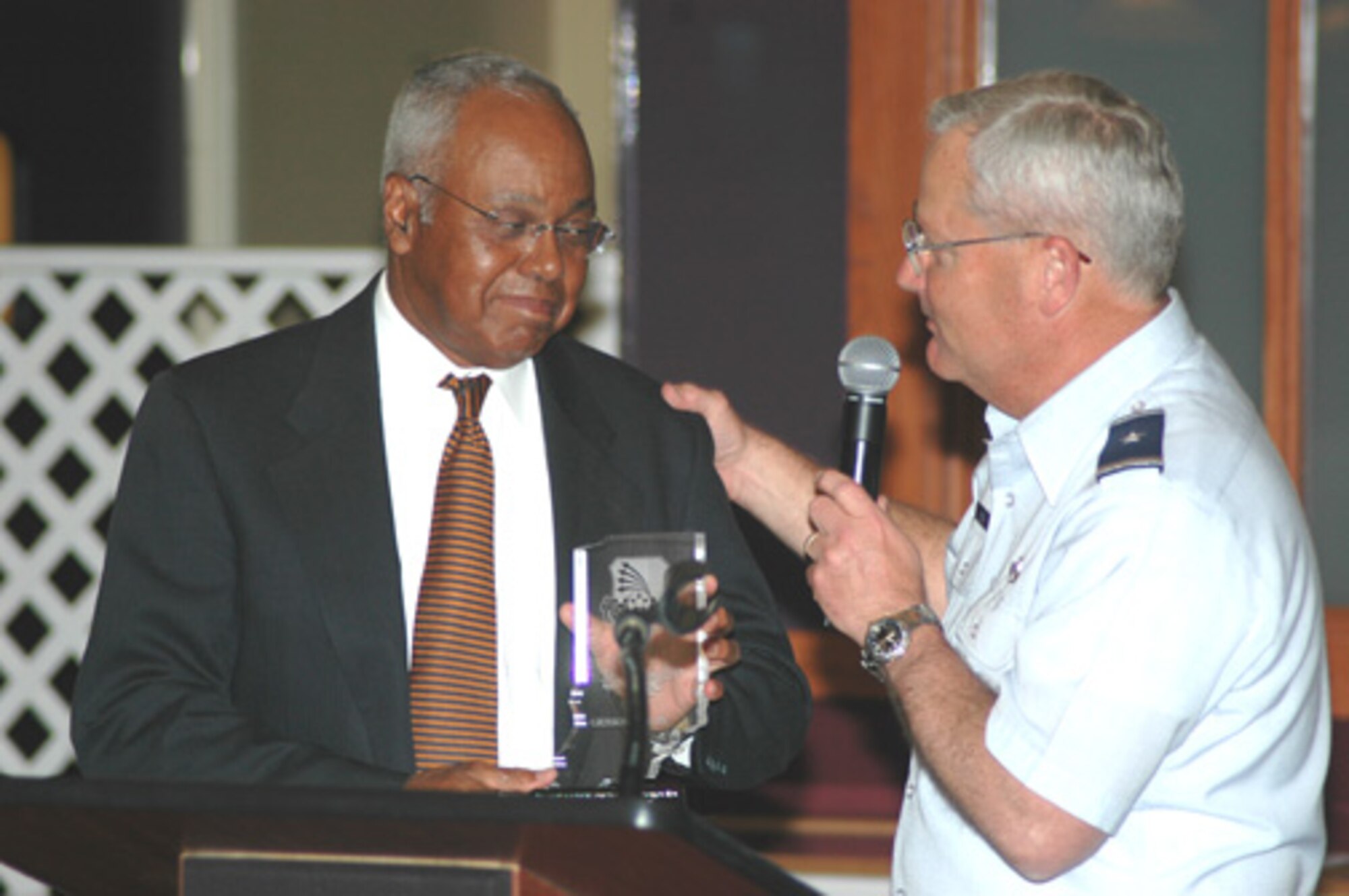 Brig. Gen. James L. Melin, 434th Air Refueling Wing commander, congratulates retired Air Force Maj. Gen. Joseph McNeil who was the keynote speaker at the Grissom Air Reserve Base multicultural banquet on May 6, 2006.  (U.S. Air Force photo/SrA Chris Bolen)