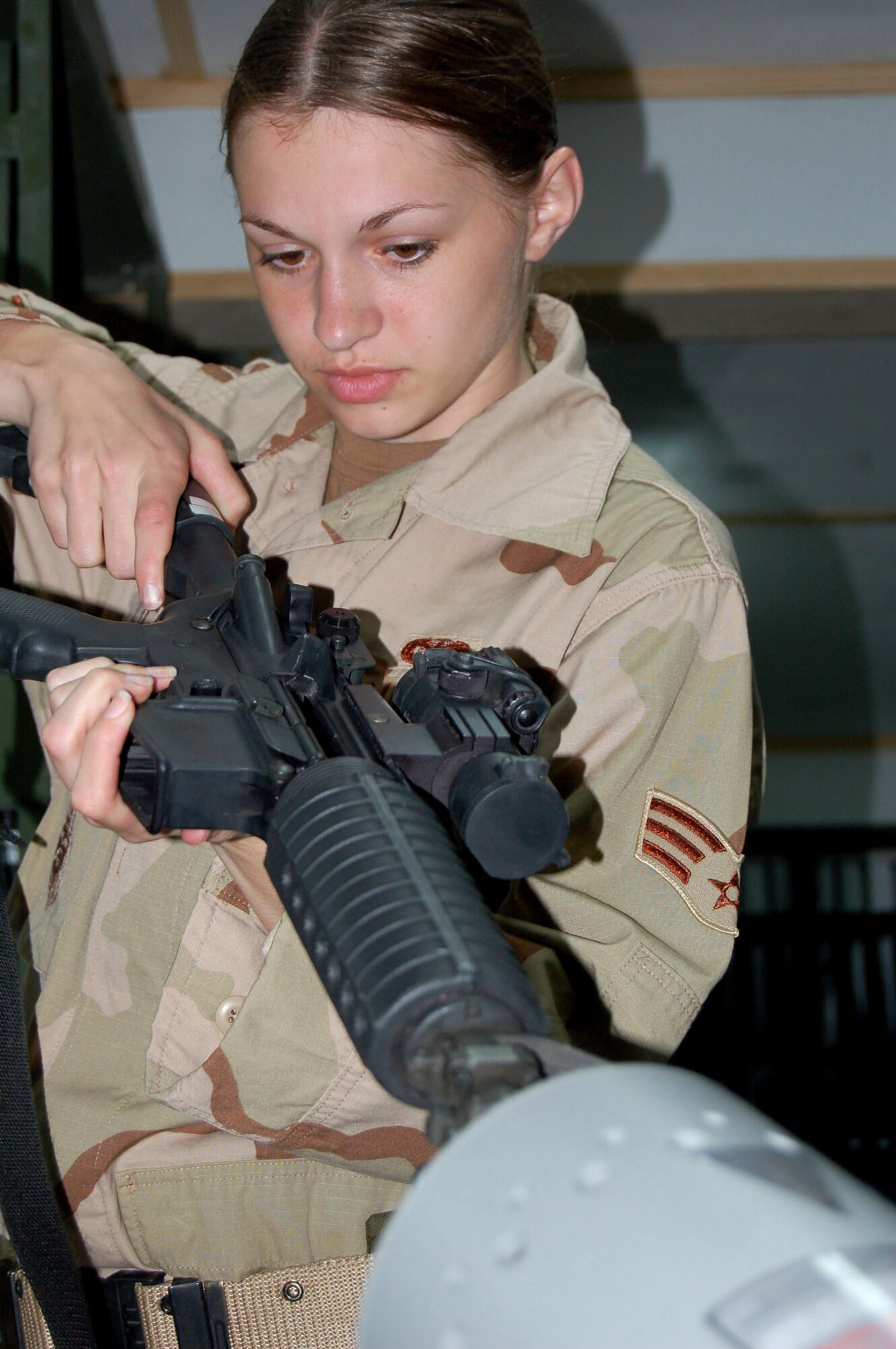 Senior Airman Jamie DiCicco clears her weapon at a clearing barrel at Manas Air Base, Kyrgyzstan, on Wednesday, April 19, 2006. She is assigned to the 376th Expeditionary Security Forces Squadron. (U.S. Air Force photo/Master Sgt. Joe Davis)

