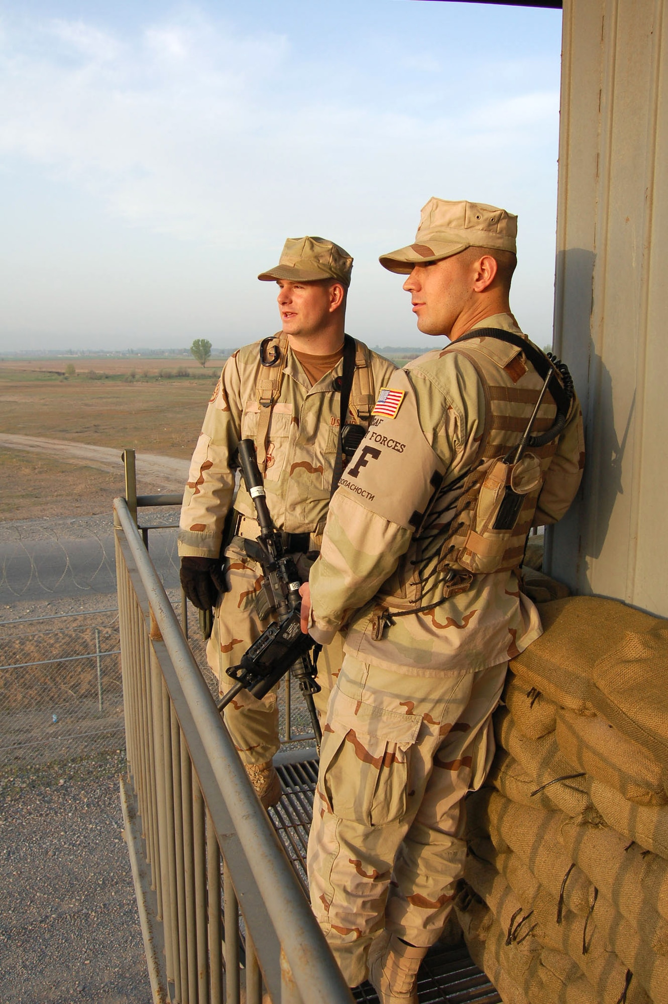 Staff Sgt. David Hoy and Senior Airman Jacob Medina survey the installation perimeter at Manas Air Base, Kyrgyzstan, on Wednesday, April 19, 2006. They are assigned to the 376th Expeditionary Security Forces Squadron. (U.S. Air Force photo/Master Sgt. Joe Davis)
