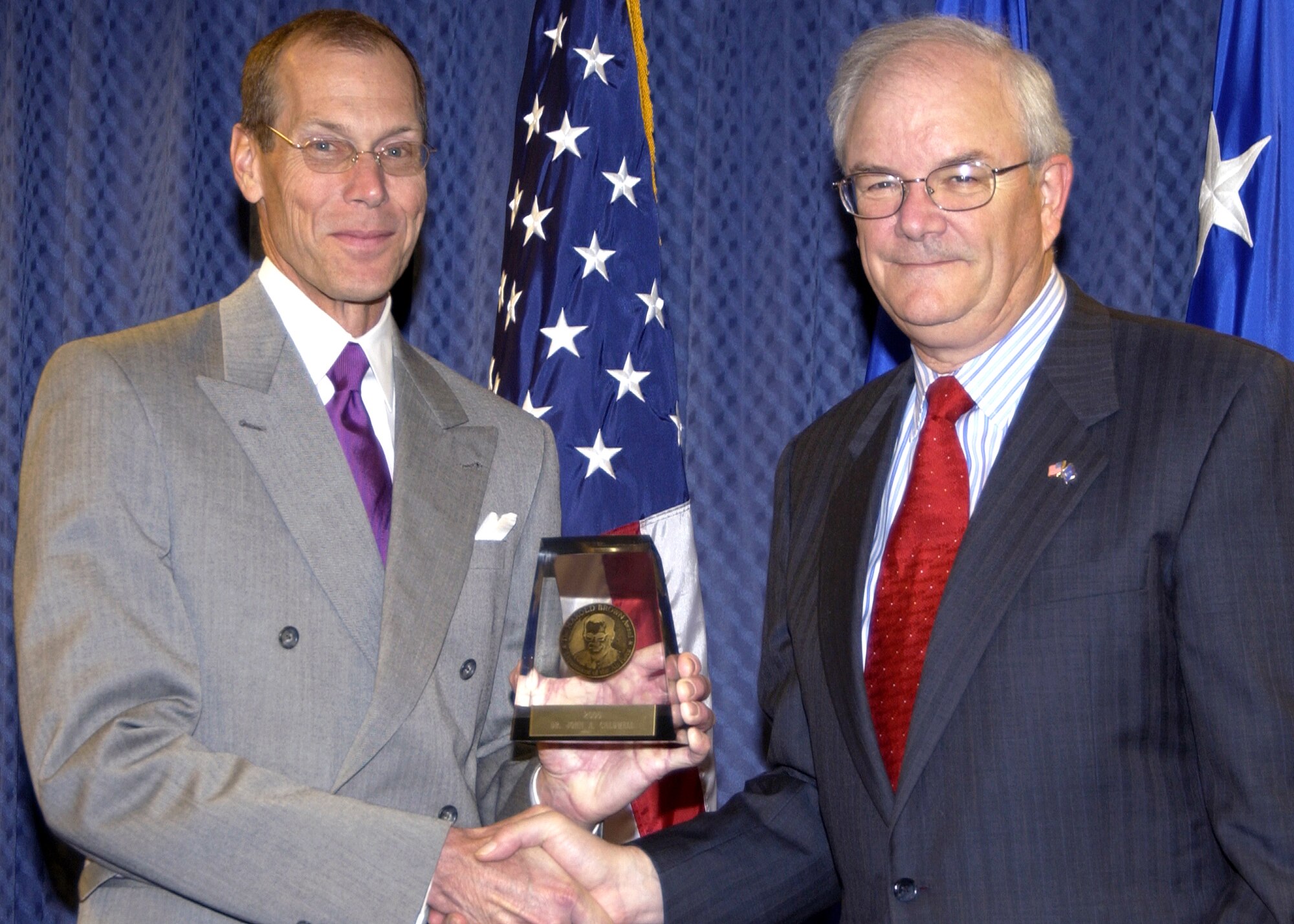 Dr. John Caldwell (left) receives the 2005 Harold Brown Award from Secretary of the Air Force Michael W. Wynne during a Pentagon ceremony on Thursday, May 4, 2006. Dr. Caldwell was recognized for his research on the effects of fatigue and how Air Force pilots can counter it. (U.S. Air Force photo/Mickey W. Sanborn)


