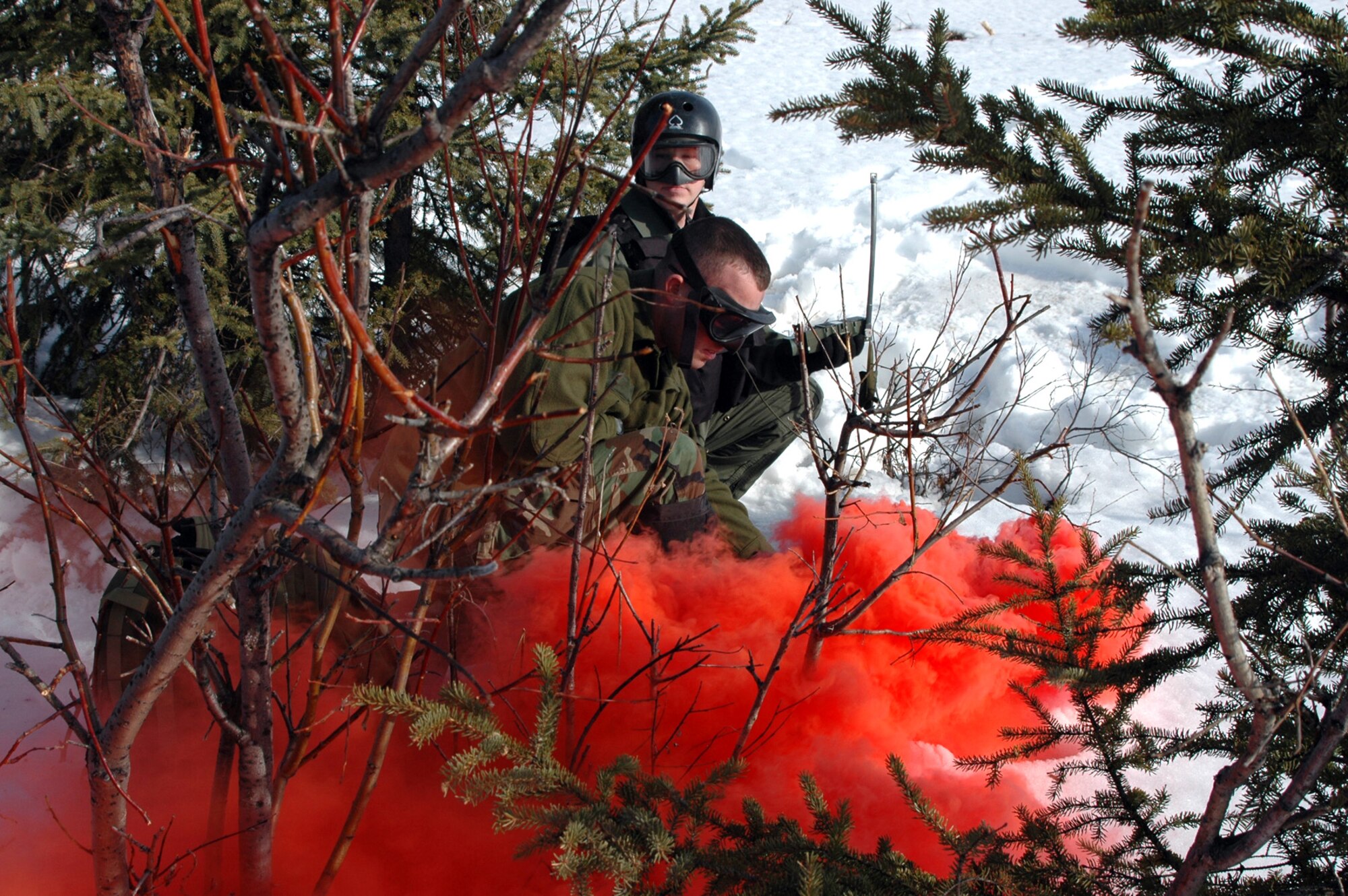 Staff Sgt. Marc Richard (front) pops red smoke as Capt. Ryan Pumford watches for a recovery vehicle during combat search and rescue training at Eielson Air Force Base, Alaska, on Tuesday, May 2, 2006, during Red Flag-Alaska. Sergeant Richard is a survival, evasion, rescue and escape specialist with Detachment 1 of the 353rd Combat Training Squadron at Elmendorf AFB, Alaska. Captain Pumford is an F-16 pilot with the 18th Fighter Squadron at Eielson. (U.S. Air Force photo/Tech. Sgt. Jeff Walston)