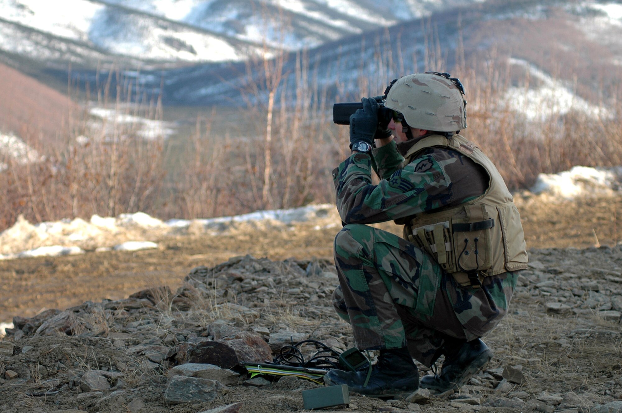 Senior Airman Glenn Wilderman scans the bombing range at Eielson Air Force Base, Alaska, for target distance and directions as his team participates in Red Flag-Alaska on Friday, April 28, 2006. Airman Wilderman is a joint terminal attack controller with the 25th Air Support Operations Squadron at Hickam AFB, Hawaii. (U.S. Air Force photo/Tech. Sgt. Jeff Walston)