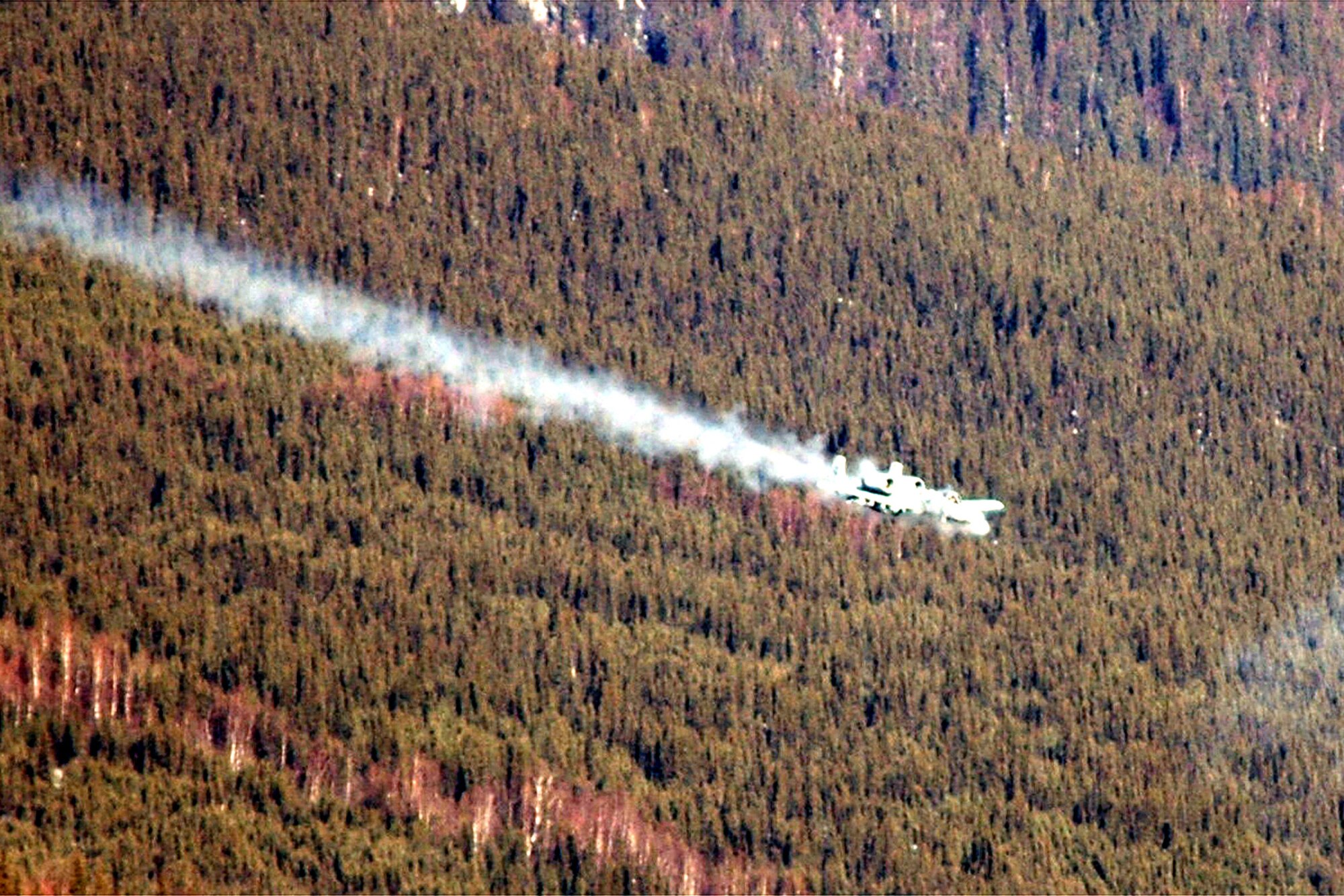 An A-10 Thunderbolt II fires at a target with its 30mm Gatling gun on the range at Eielson Air Force Base, Alaska, on Friday, April 28, 2006, during Red Flag-Alaska. Joint terminal attack controllers from the 25th Air Support Operations Squadron at Hickam AFB, Hawaii, called in air support and directed planes to their targets as part of the exercise. The A-10 is from the 75th Fighter Squadron at Pope AFB, N.C. (U.S. Air Force photo/Tech. Sgt. Jeff Walston)